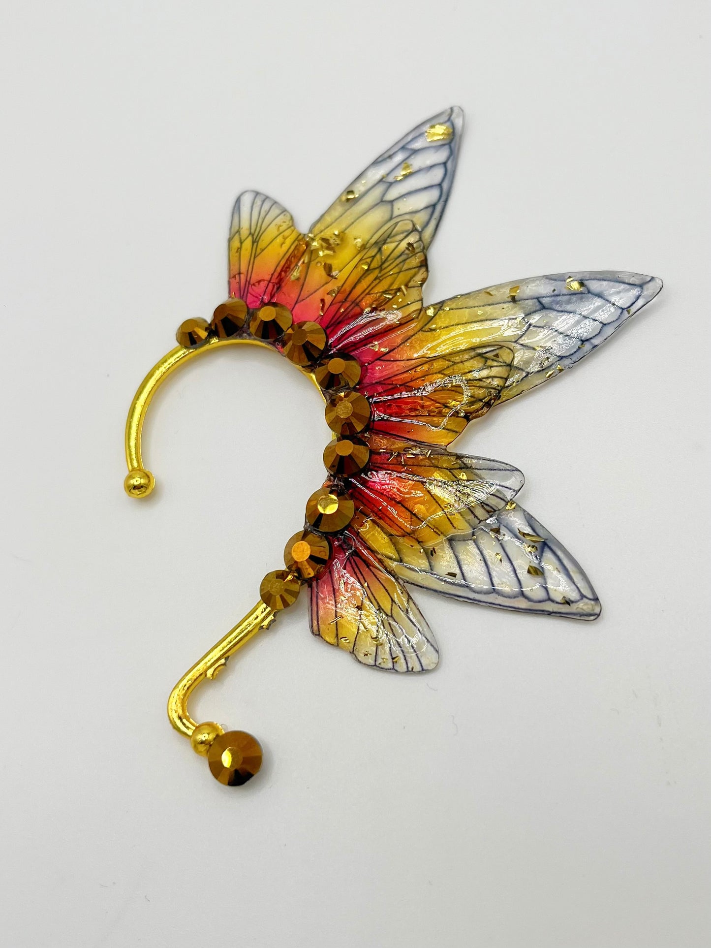Yellow and red fairy wing ear cuff with gold rhinestone accents.