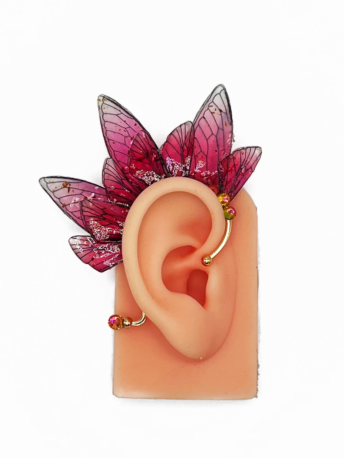 Red fairy wing ear cuff modeled on an ear.