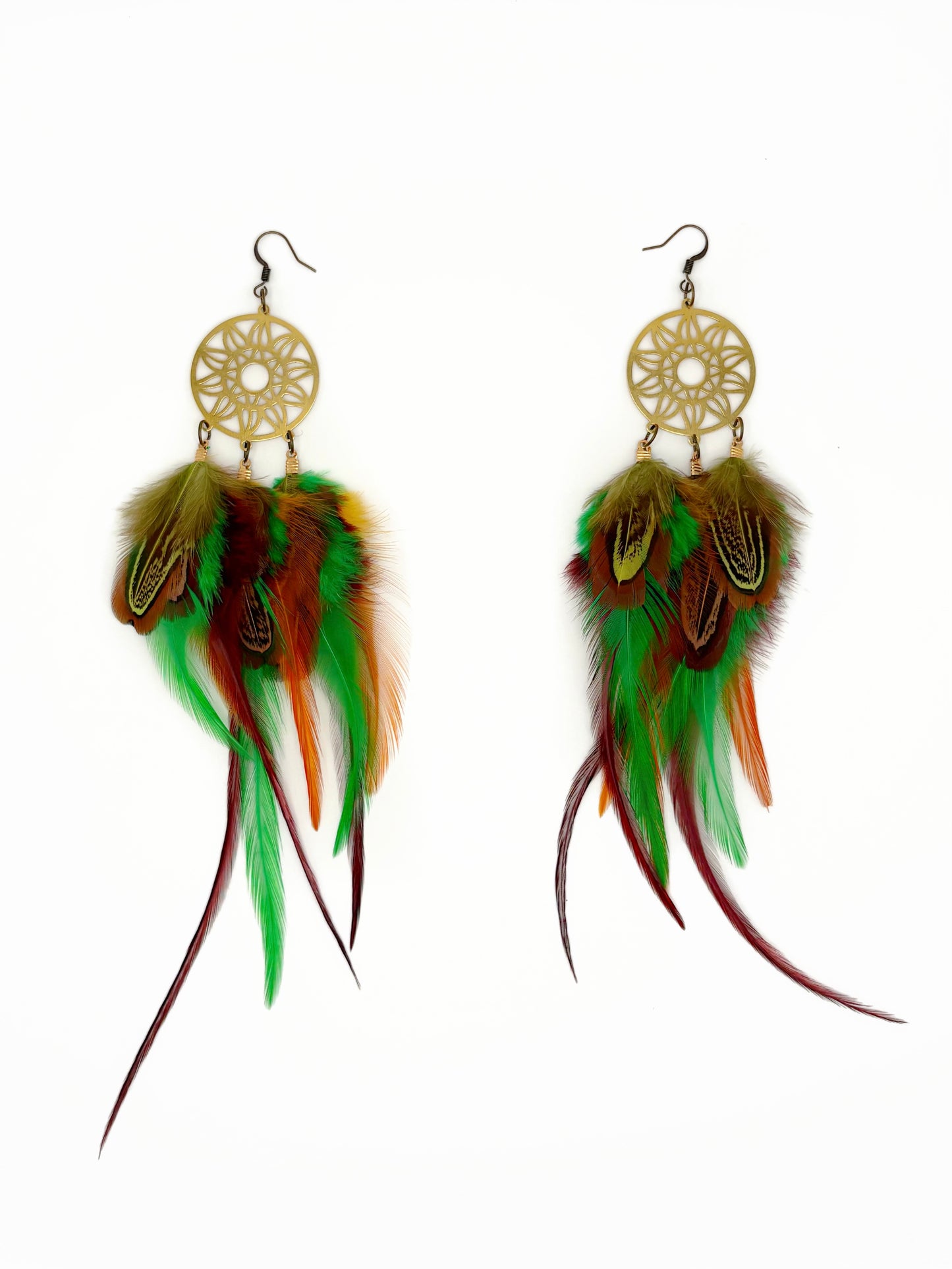 Feather earrings with gold circular designs on a white background