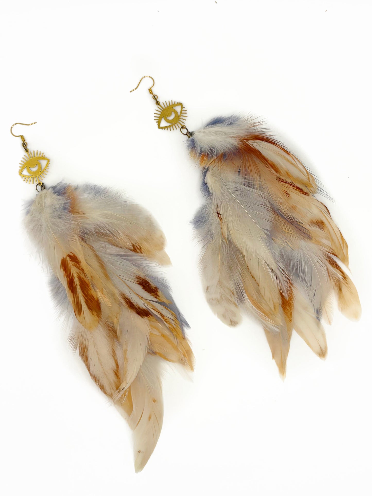 Long cream colored feather earrings.