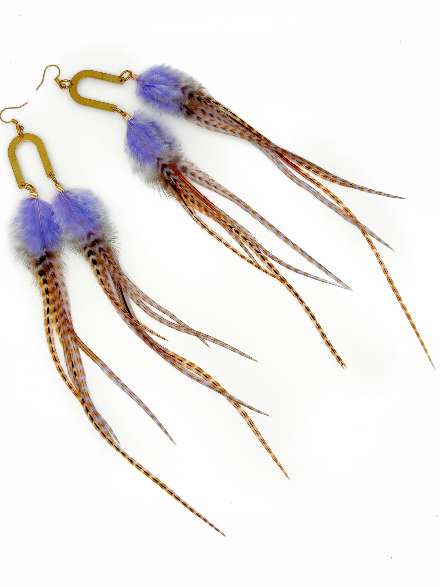 Feathered earrings with purple accents on a white background
