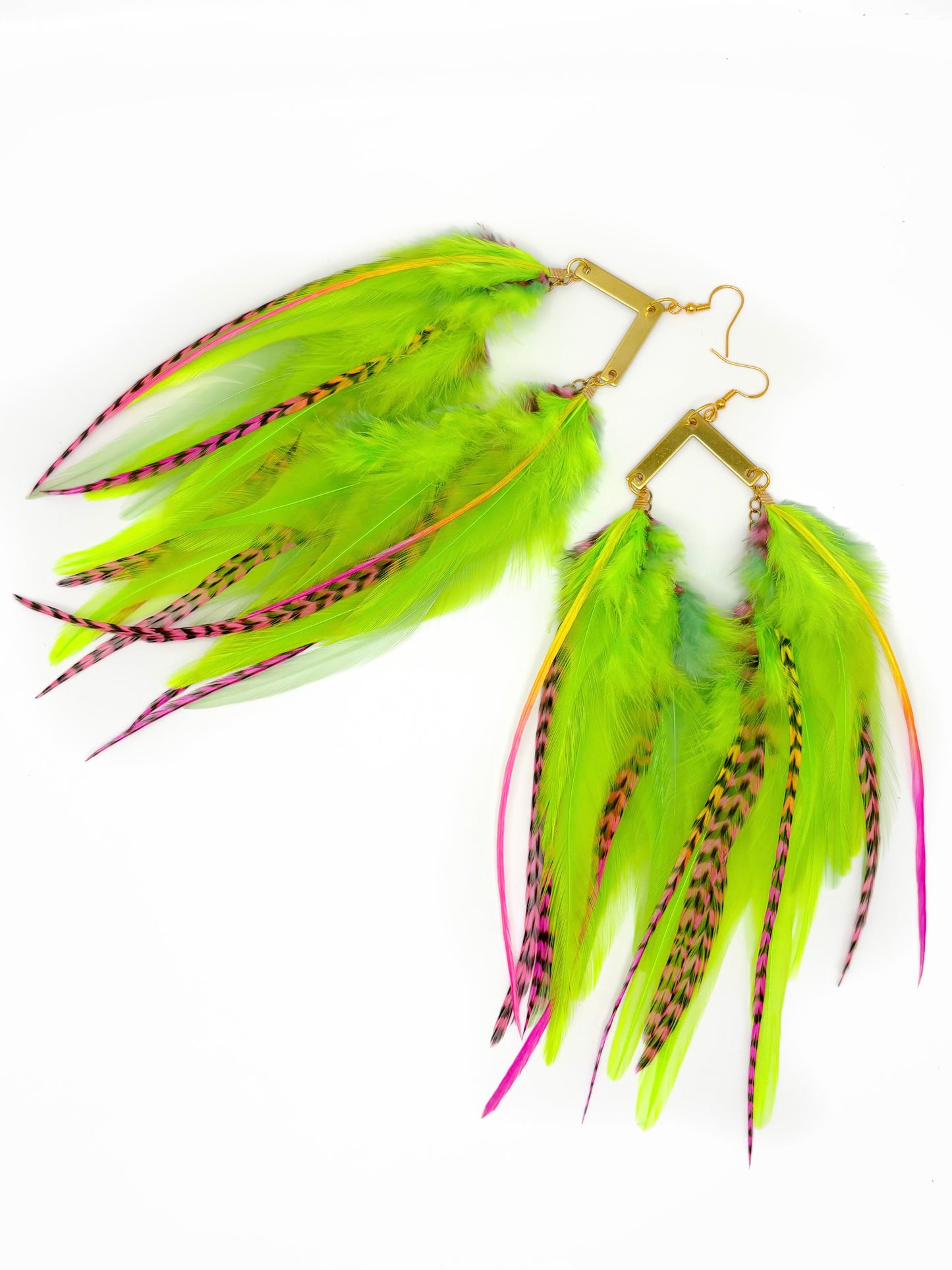Green feather earrings with pink accents on a white background