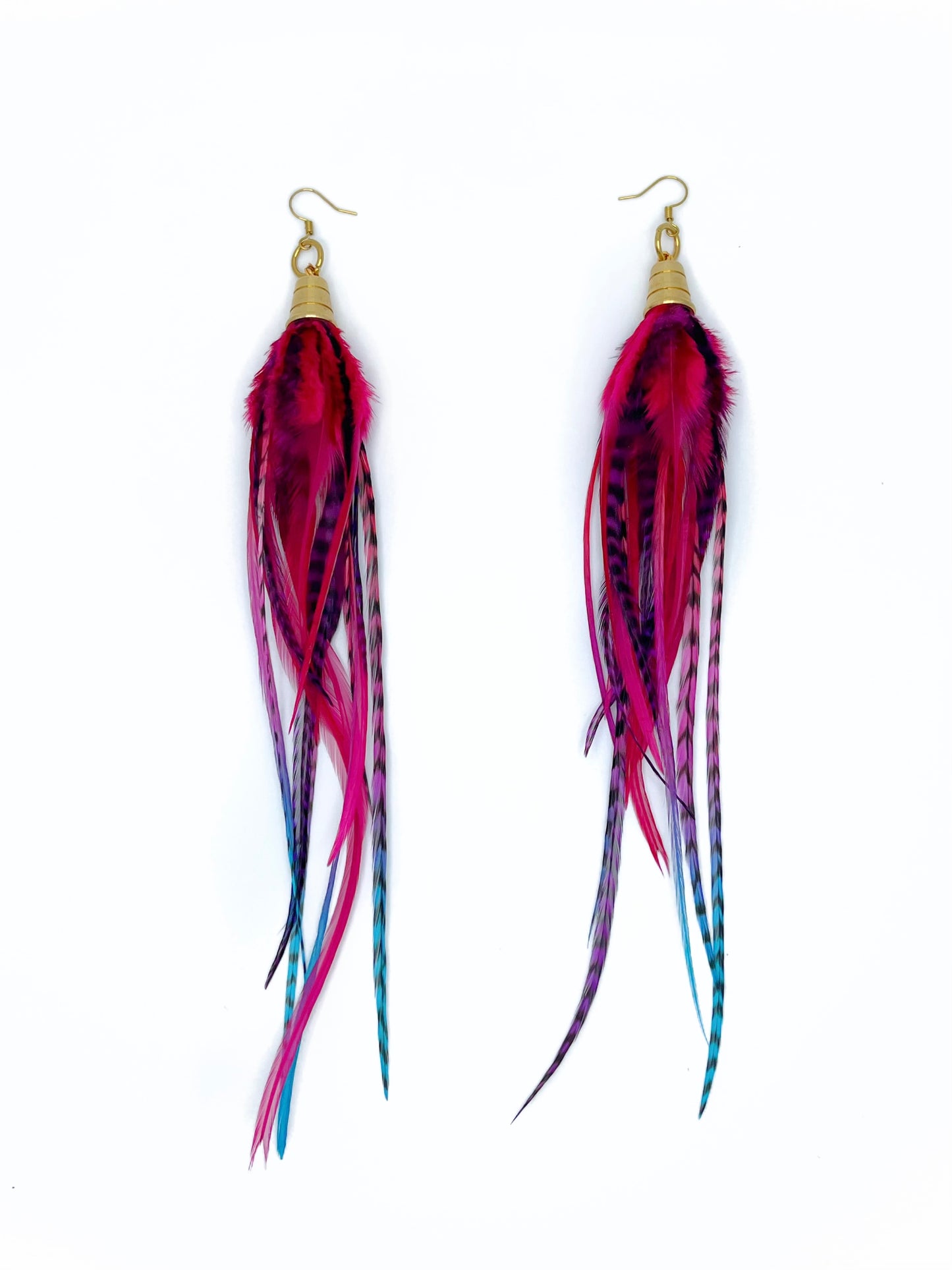 Long pink, purple and blue feather earrings. All feathers hang under a gold colored pendant.