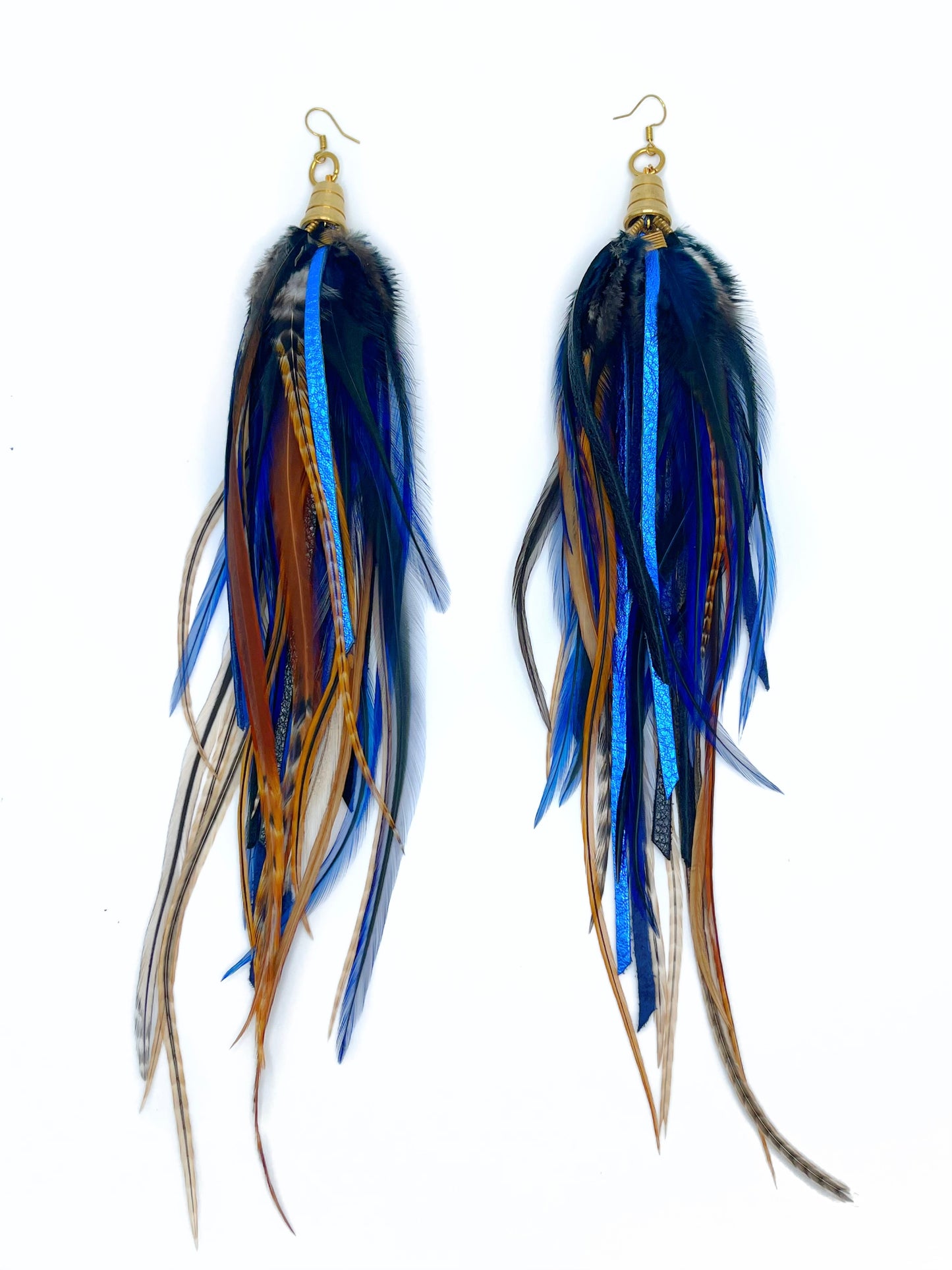 Long feather and leather earrings in dark blue and brown tones. All feathers hang from underneath a gold cap pendant.