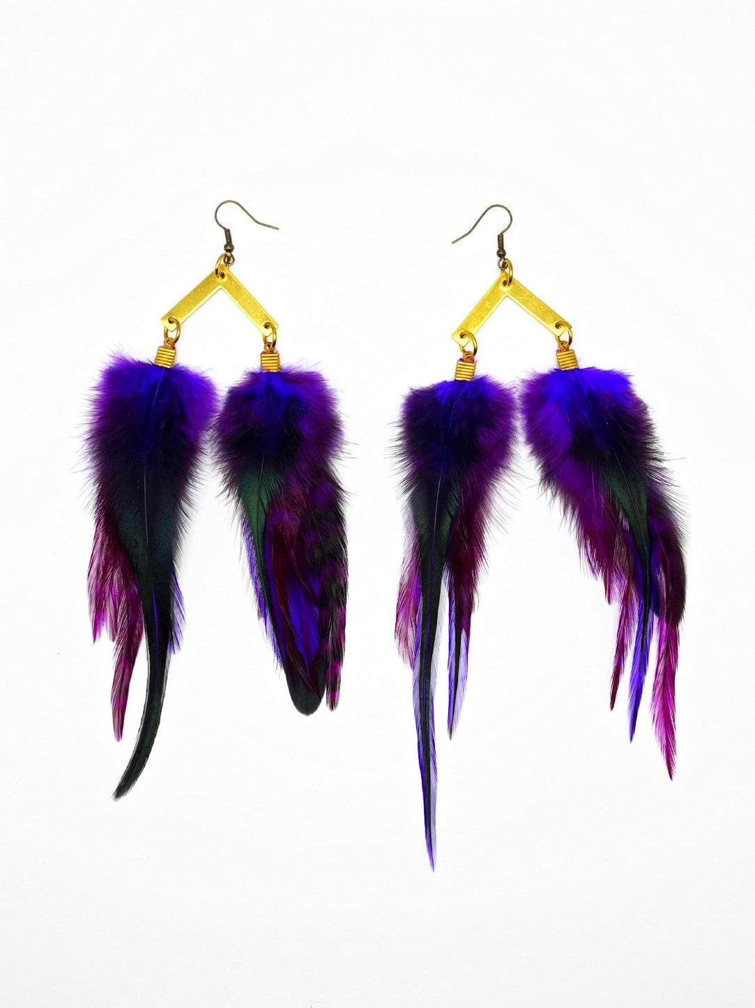 A pair of luxurious bohemian-style feather earrings, showcasing a rich gradient of purple to deep black. They are elegantly attached to gold geometric-shaped hardware, providing a sophisticated contrast against the white background. The feathers appear soft and fluffy, giving the earrings a dynamic and opulent look.
