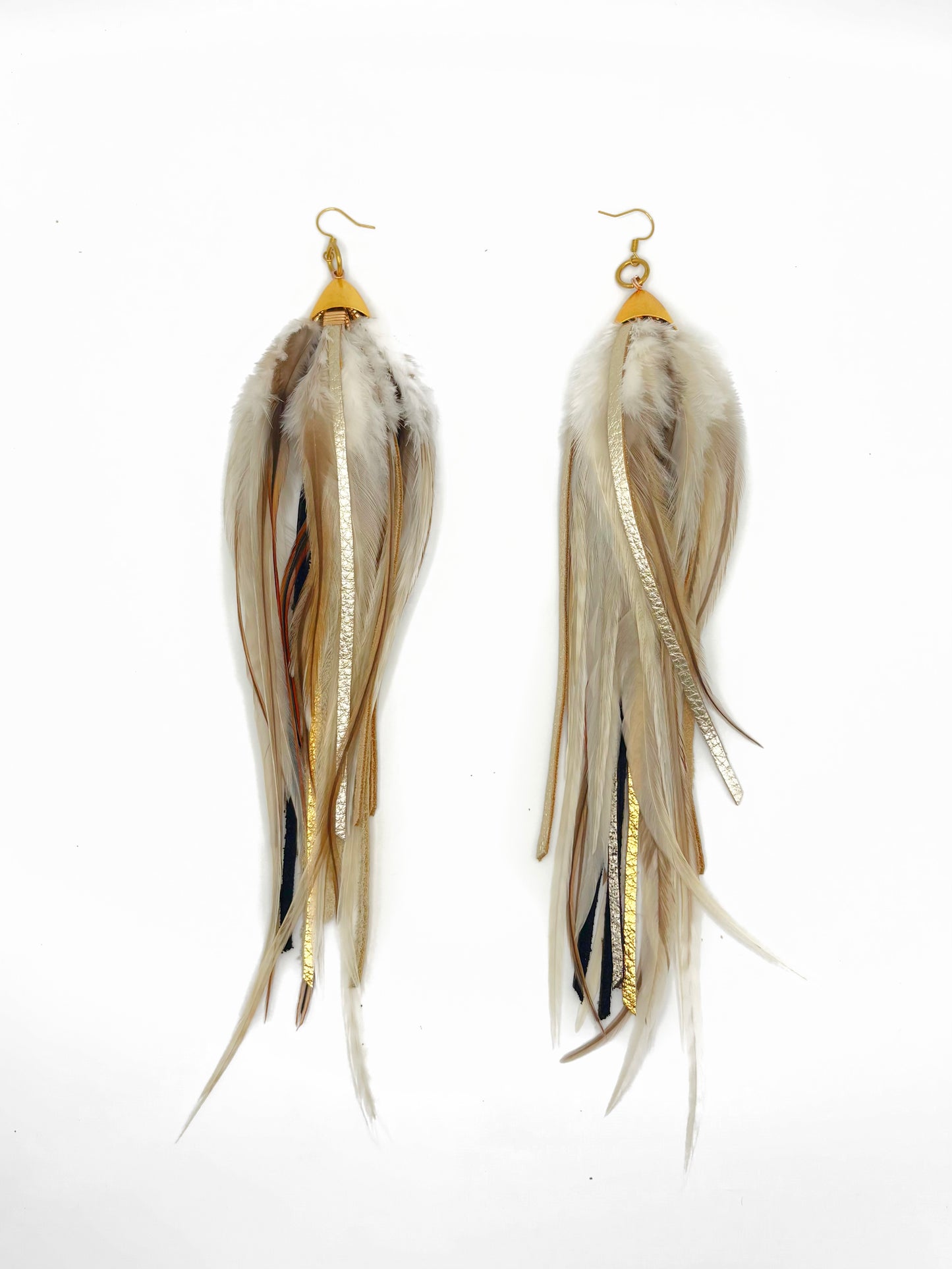 Long fluffy feather and leather earrings in natural tones.
