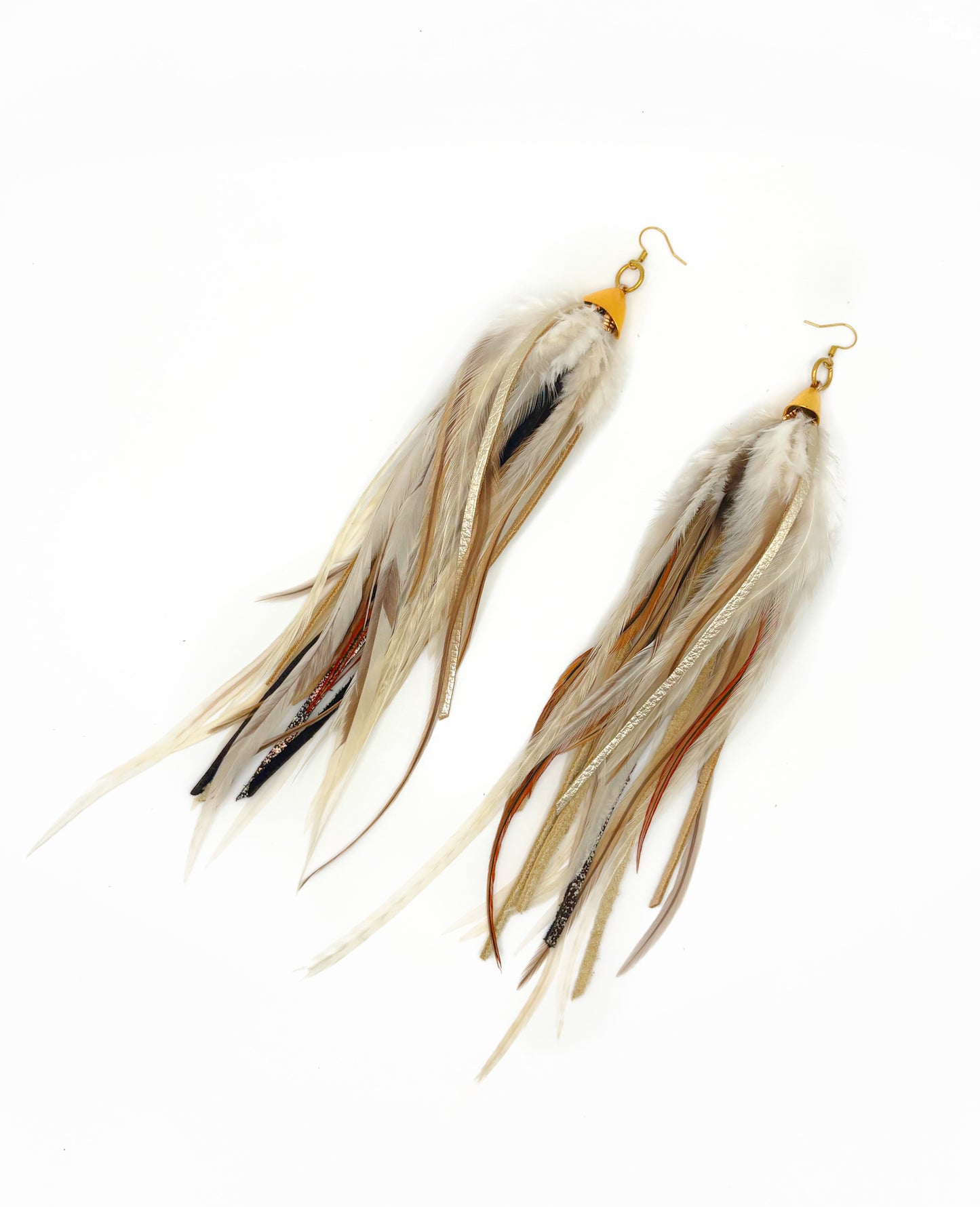 Long fluffy feather and leather earrings in natural tones.