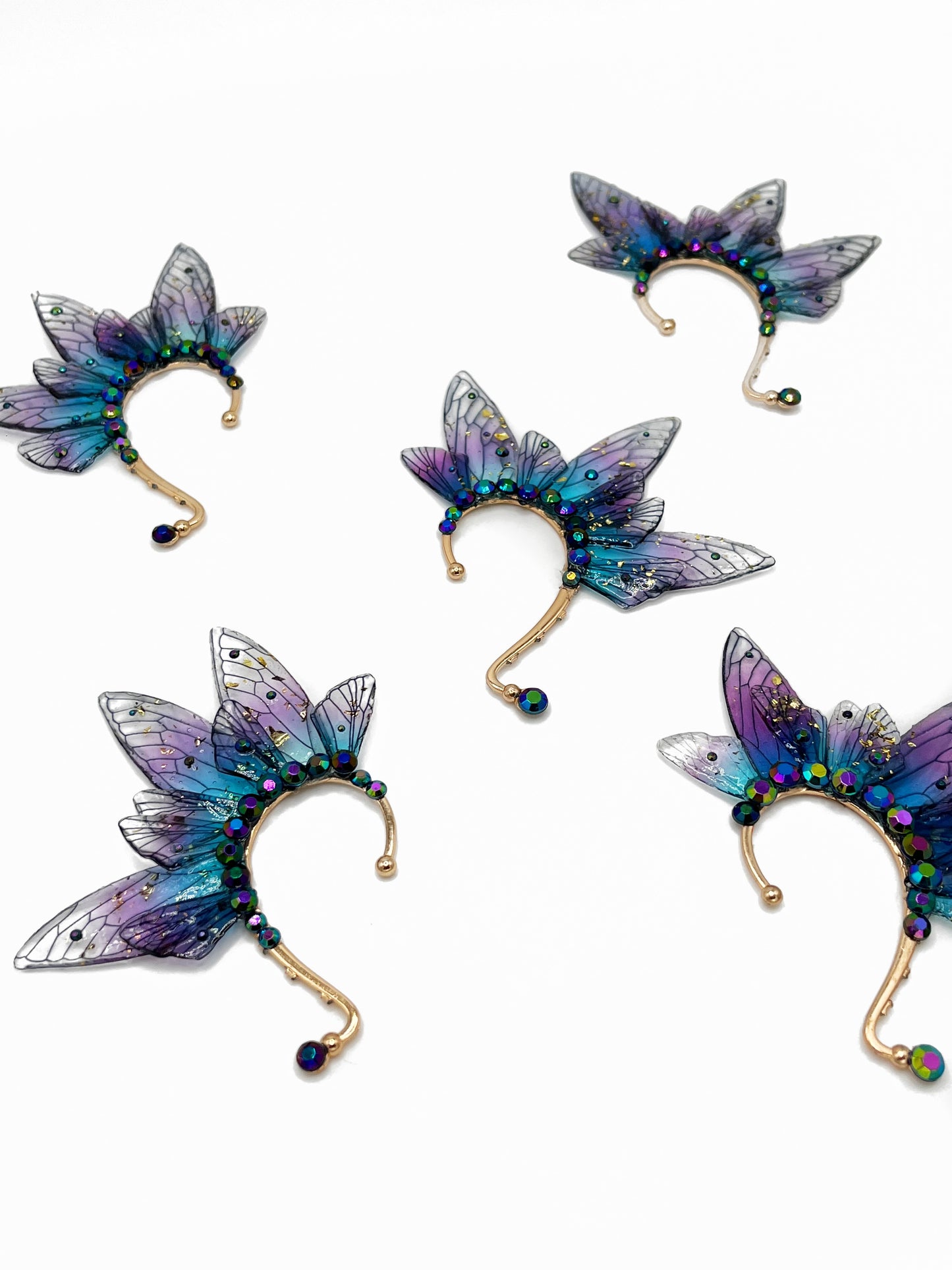 Purple and blue fairy wing ear cuffs with blue rhinestone accents.