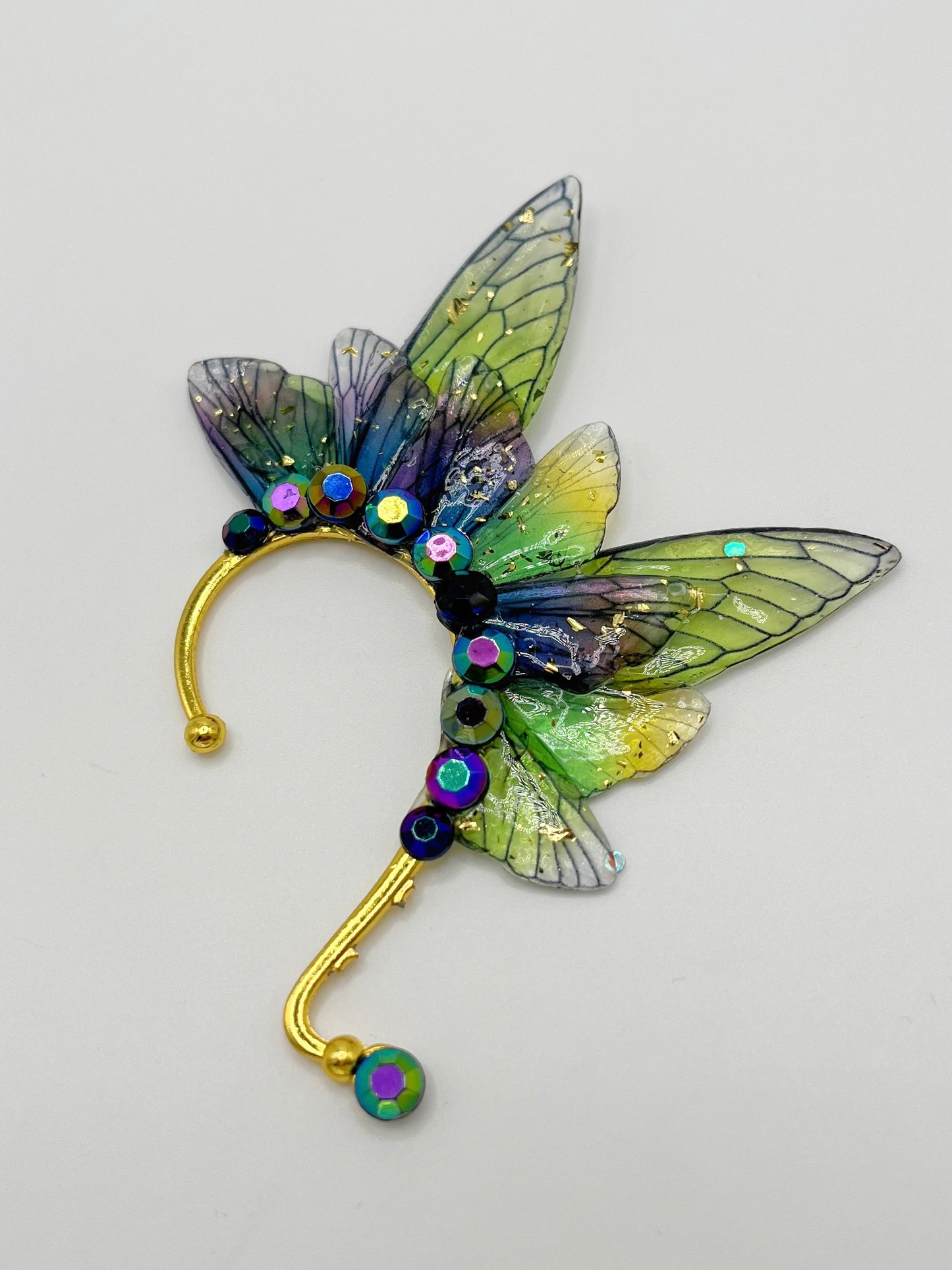Green and purple fairy wing ear cuff with blue rhinestones.