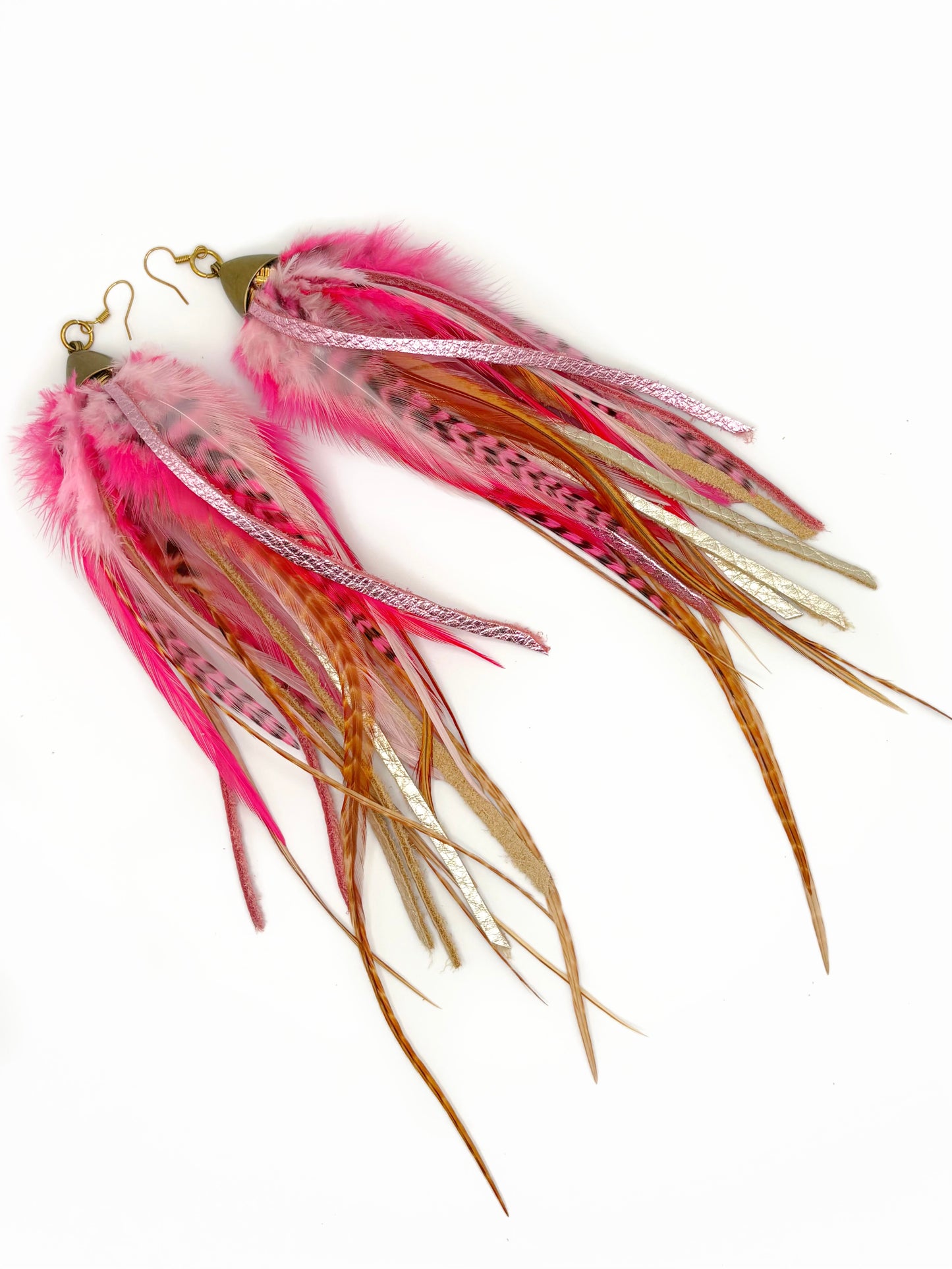 Fishing lure with pink and brown feathers on a white background