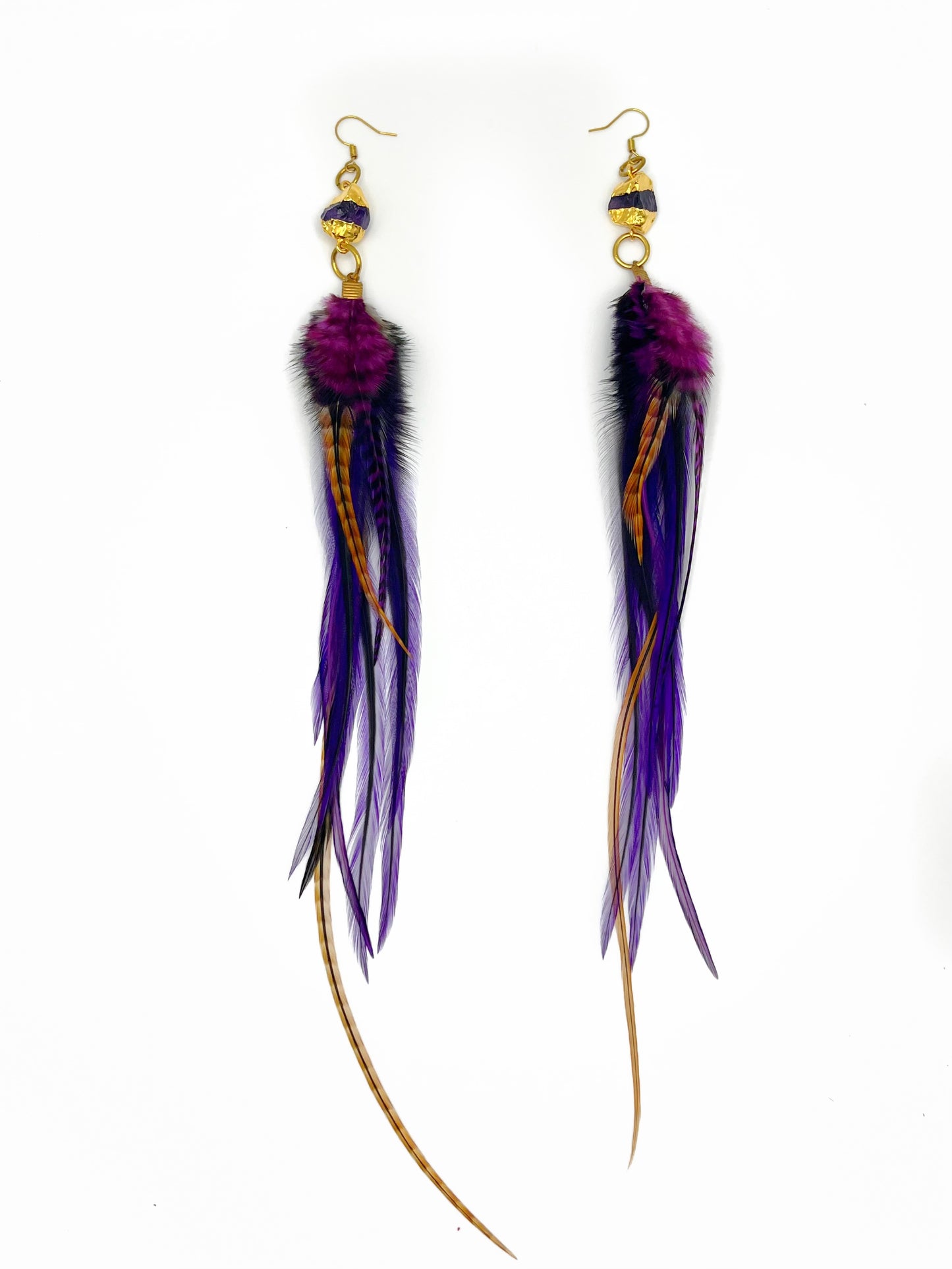 Long purple feather earrings. Feathers hang from a gold dipped amethyst pendant.