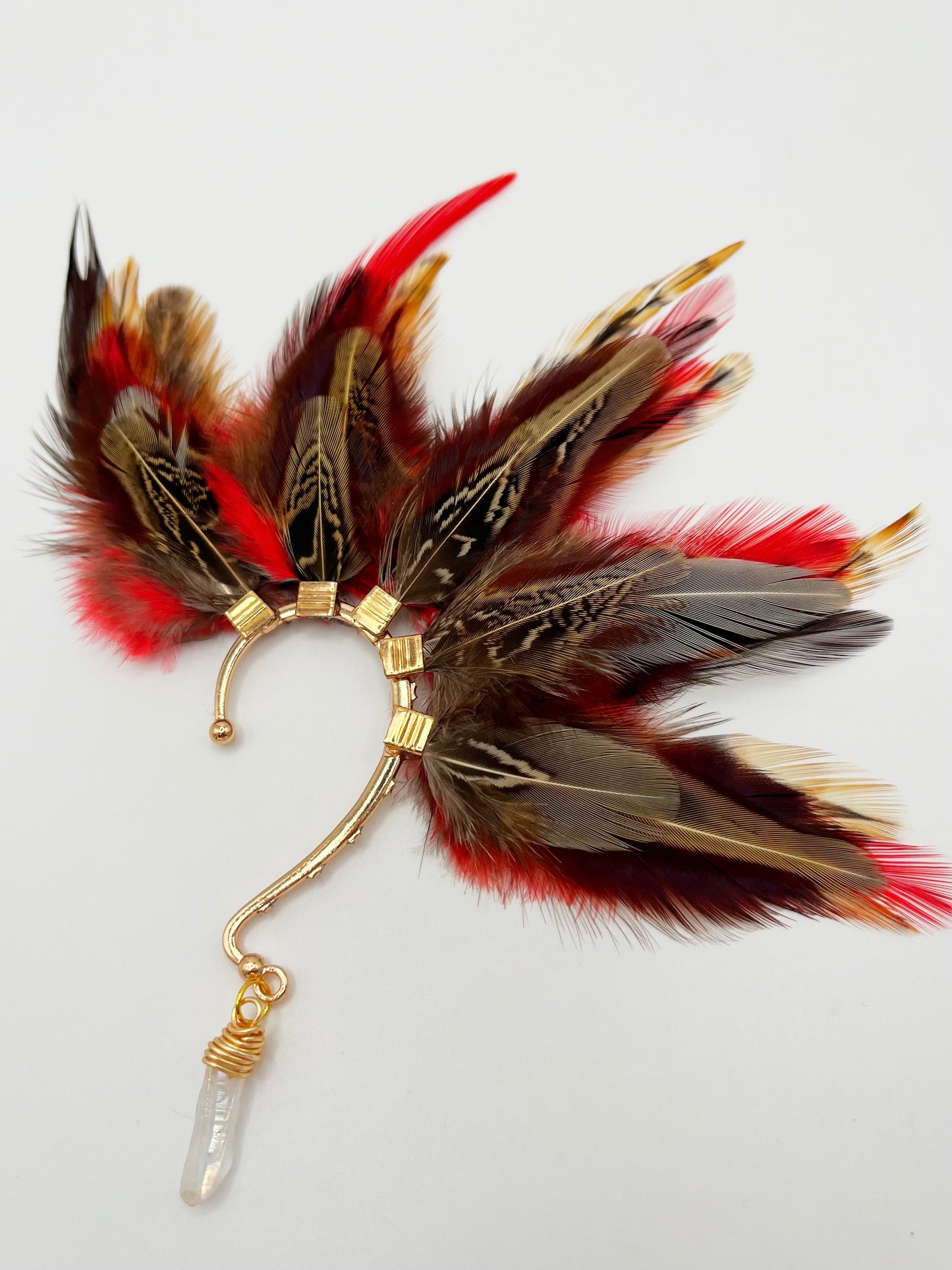 Brown pheasant and vibrant red rooster feather ear cuff with a wire wrapped quartz stone that hangs from the bottom of the cuff.