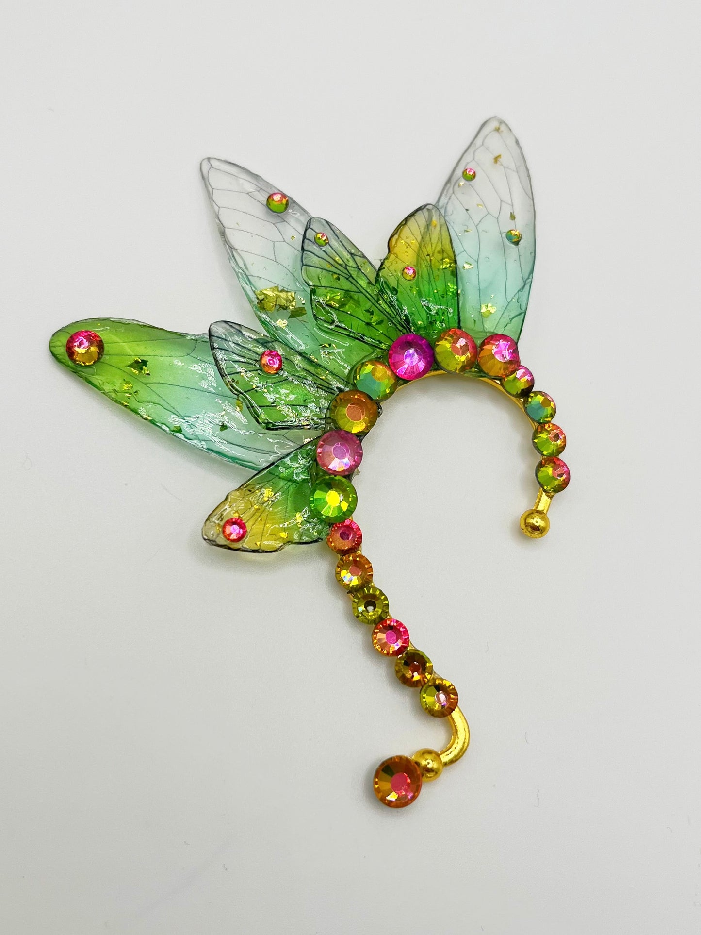 Green fairy wing ear cuff with pink rhinestone accents.