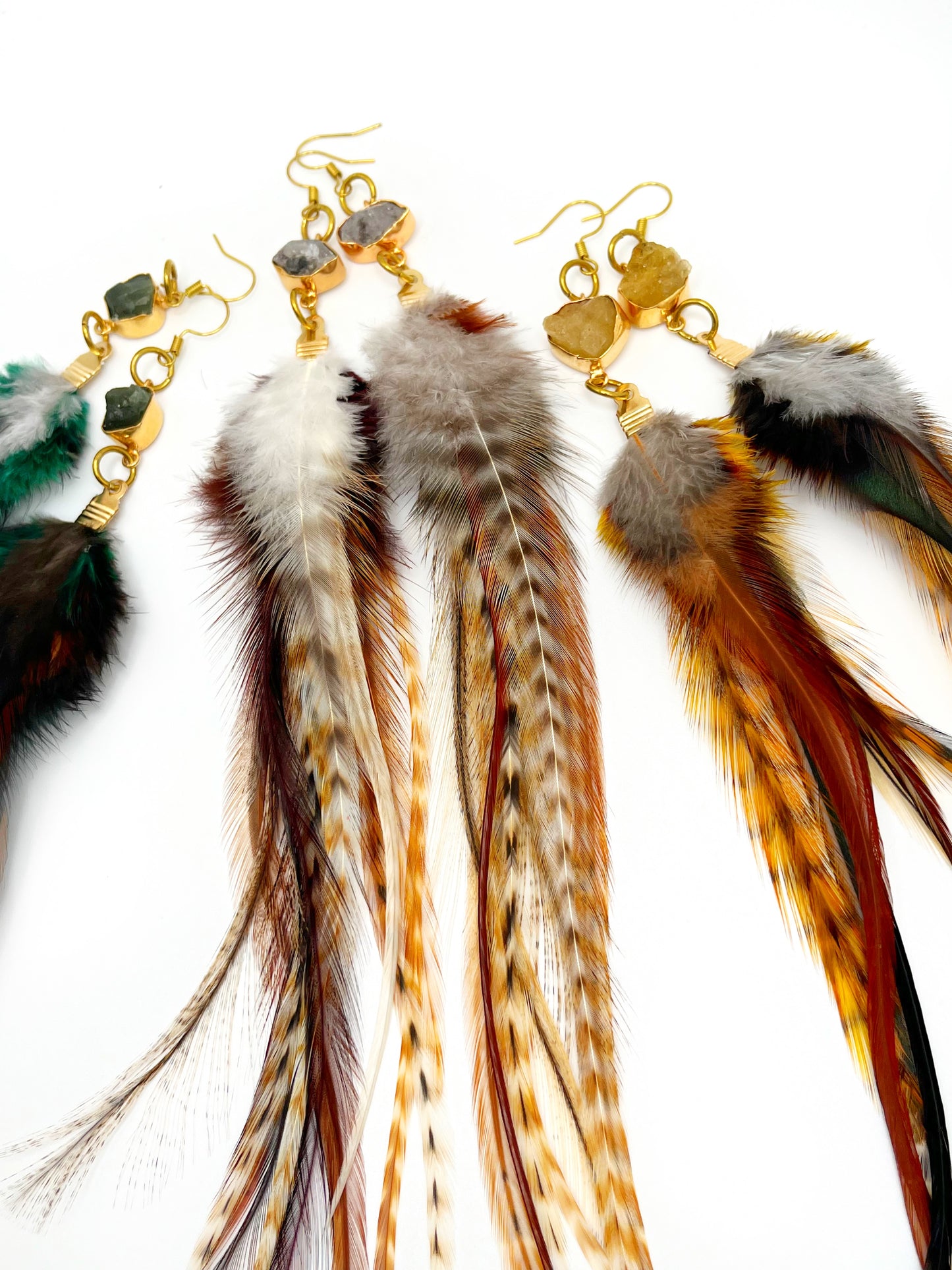 Long feather earrings with gemstone connectors.