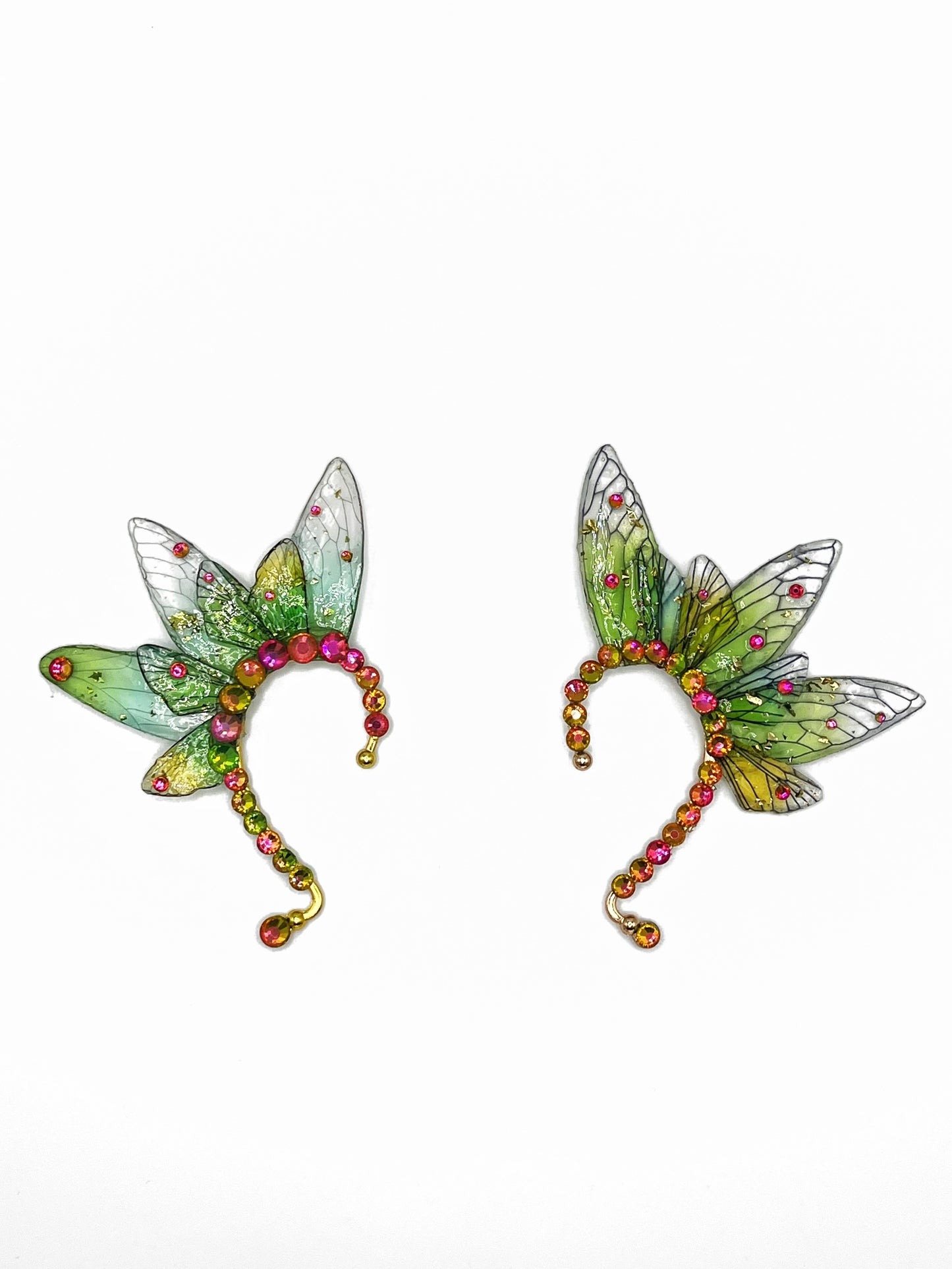 A pair of green fairy wing ear cuffs with pink rhinestone accents.