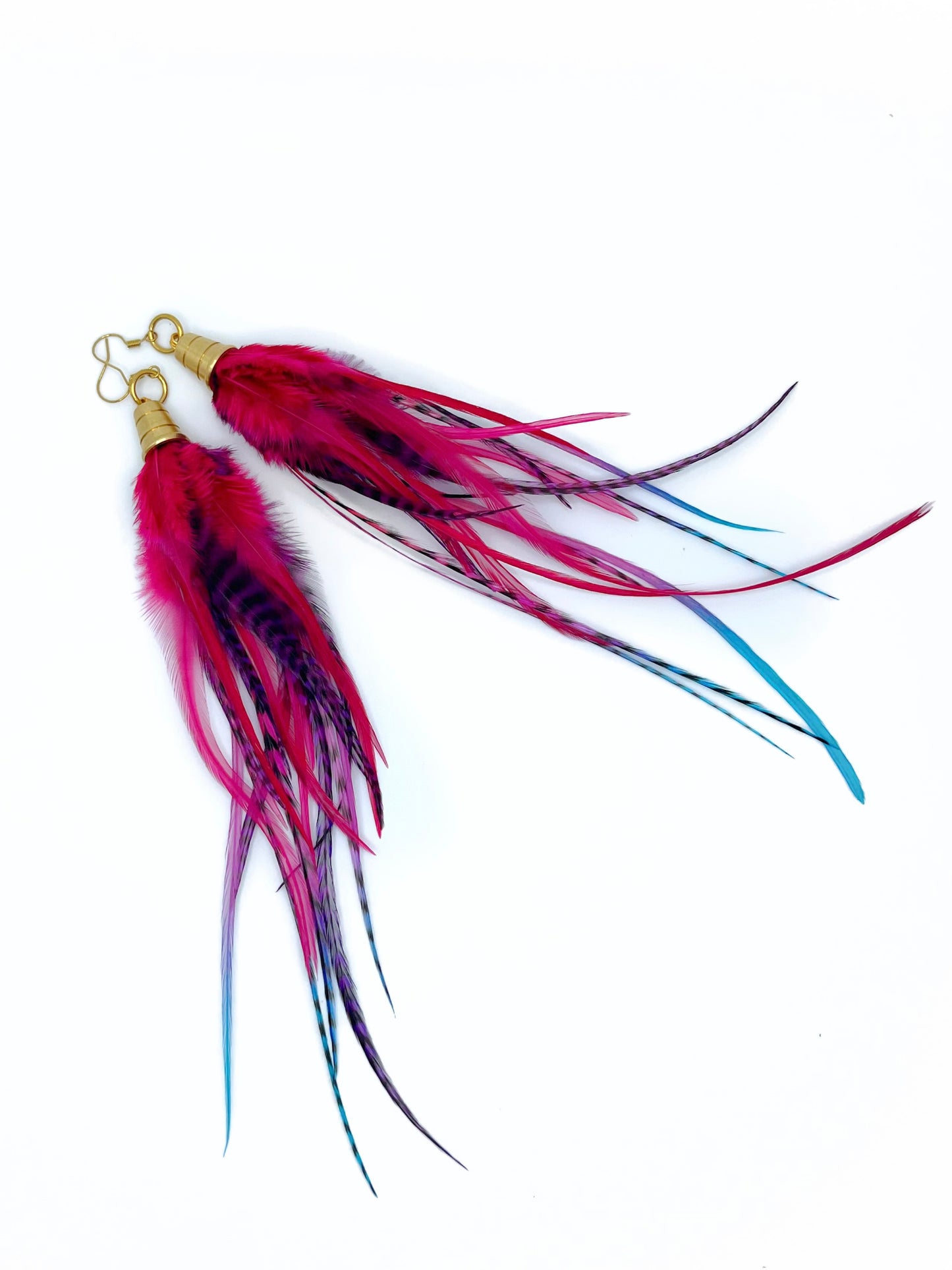 Long pink, purple and blue feather earrings. All feathers hang under a gold colored pendant.