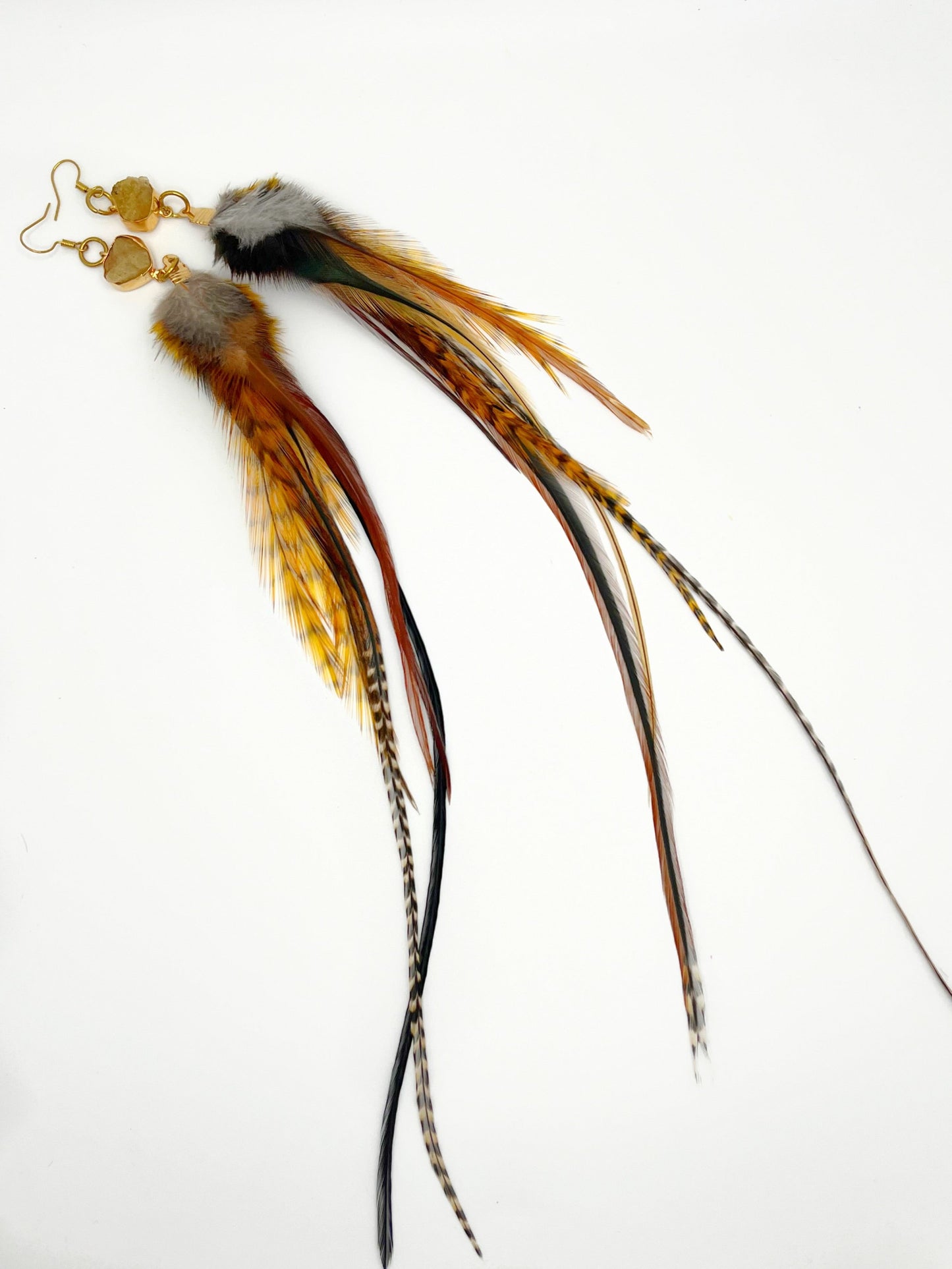 Long brown and orange feather earrings with gold citrine gemstone pendants.