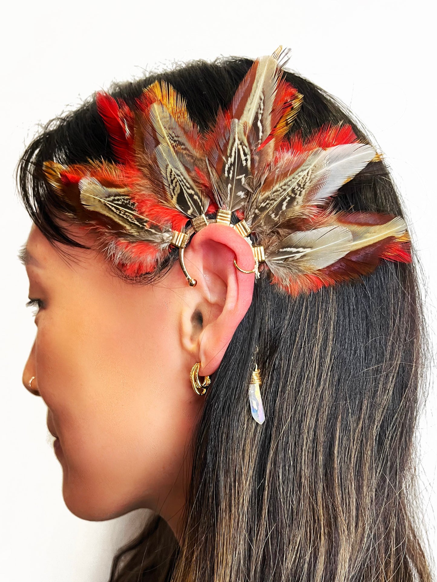 Brown pheasant and vibrant red rooster feather ear cuff, modeled on a woman.