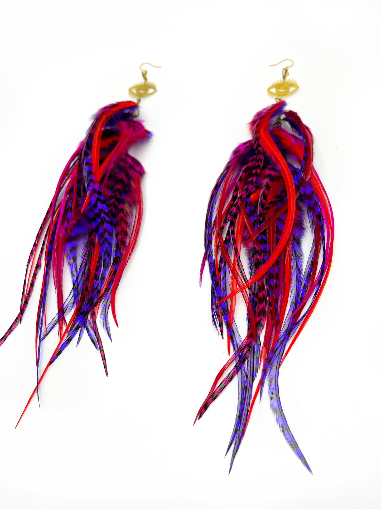 Long fluffy feather earrings in red and purple tones. All feathers hang elegantly from an evil eye pendant.