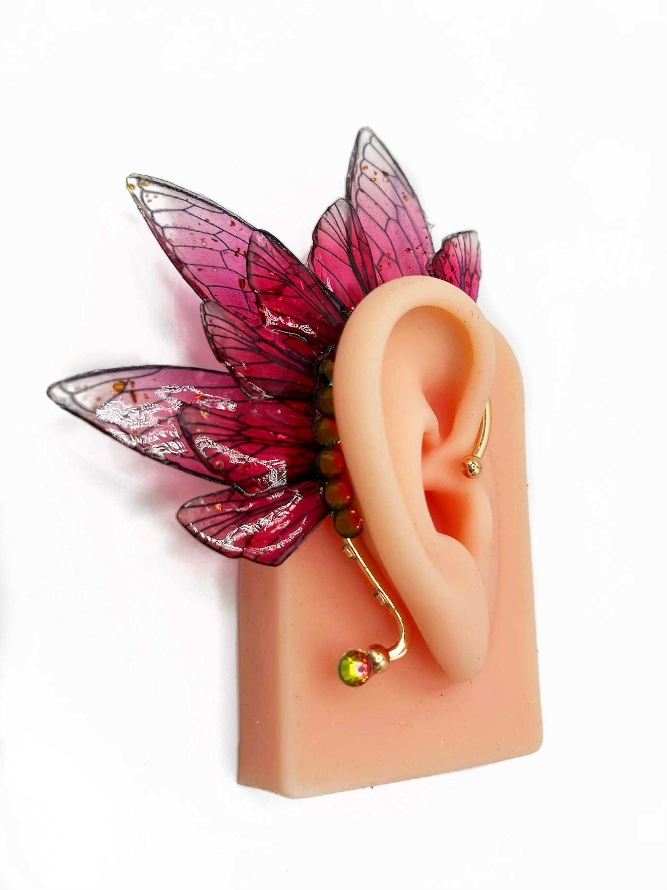 Red fairy wing ear cuff modeled on an ear.