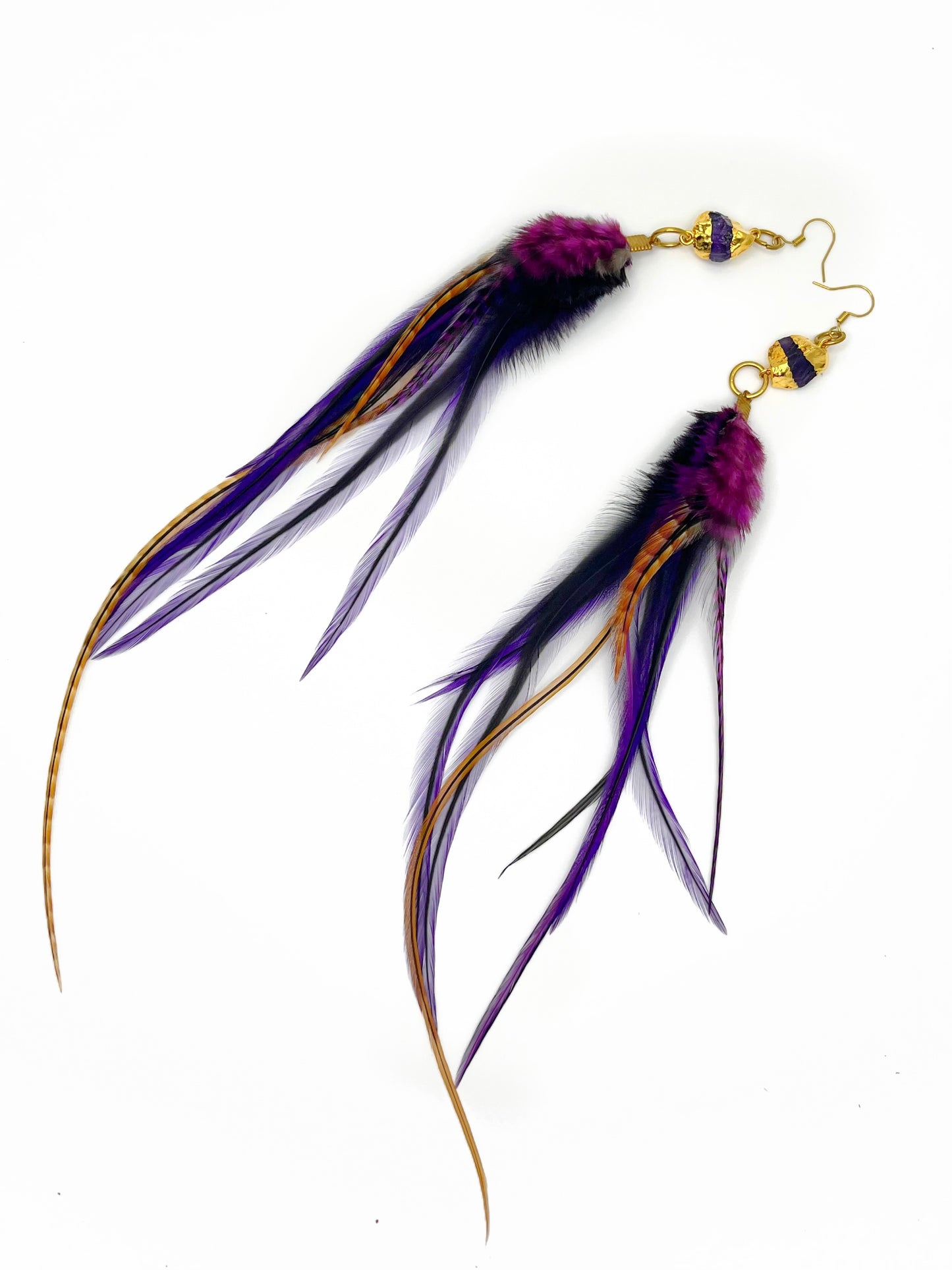 Long purple feather earrings. Feathers hang from a gold dipped amethyst pendant.