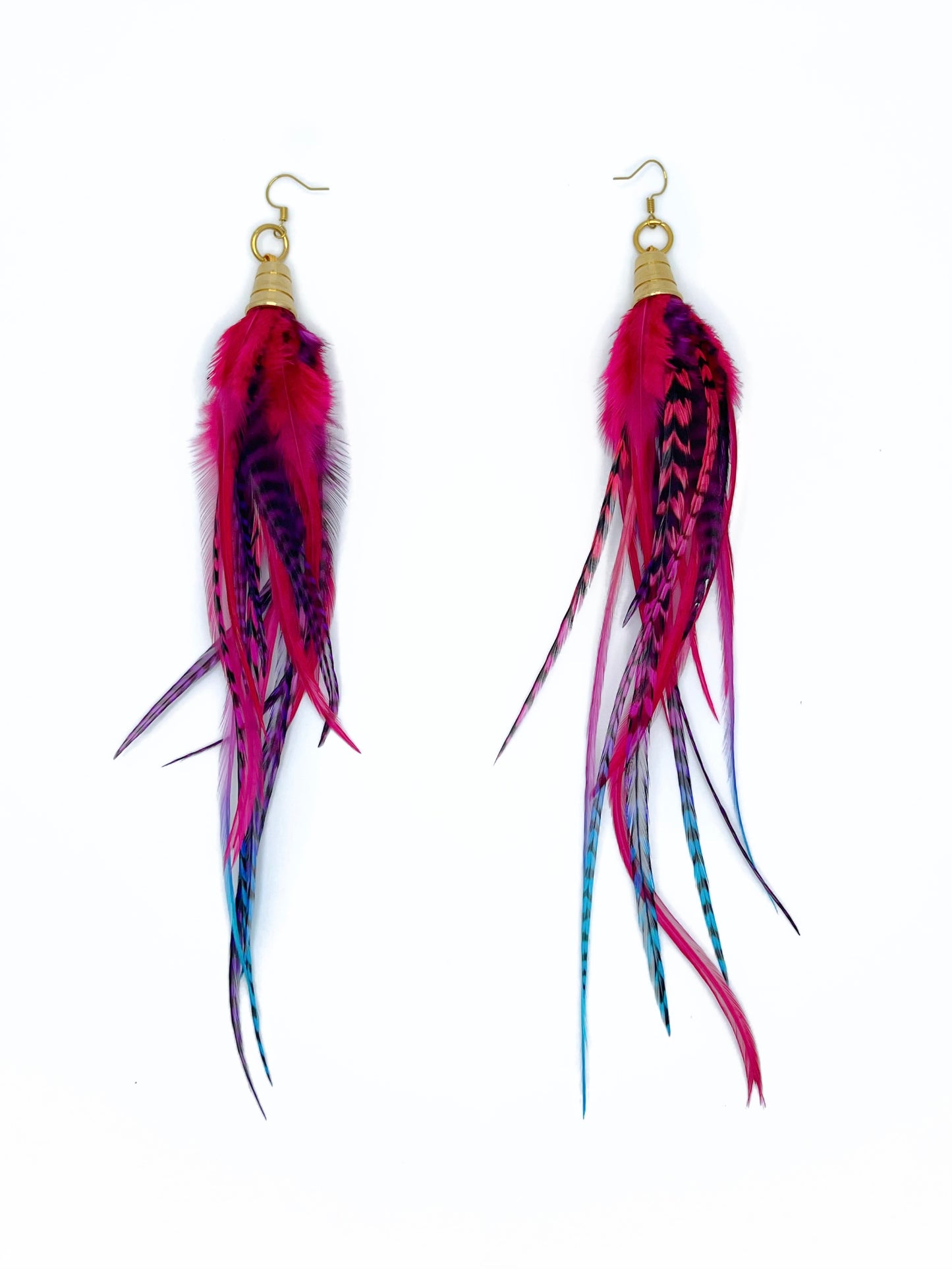 Long pink, purple and blue feather earrings. All feathers hang under a gold colored pendant.