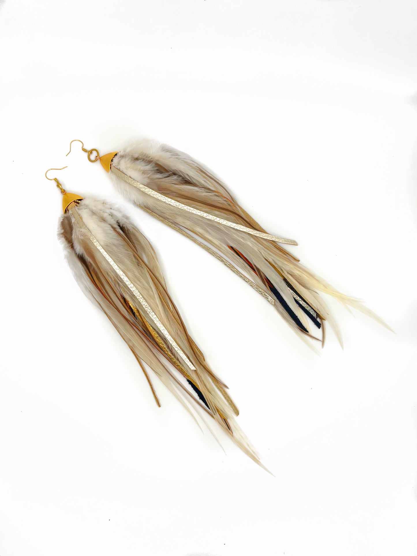 Long fluffy feather and leather earrings in natural tones.