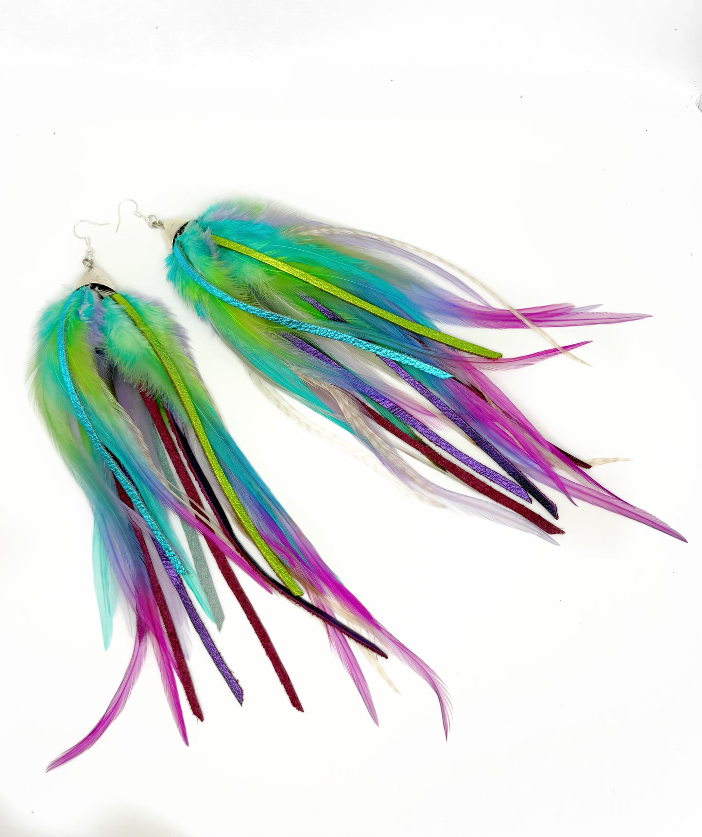 Long feather and leather earrings in blue, green and purple.