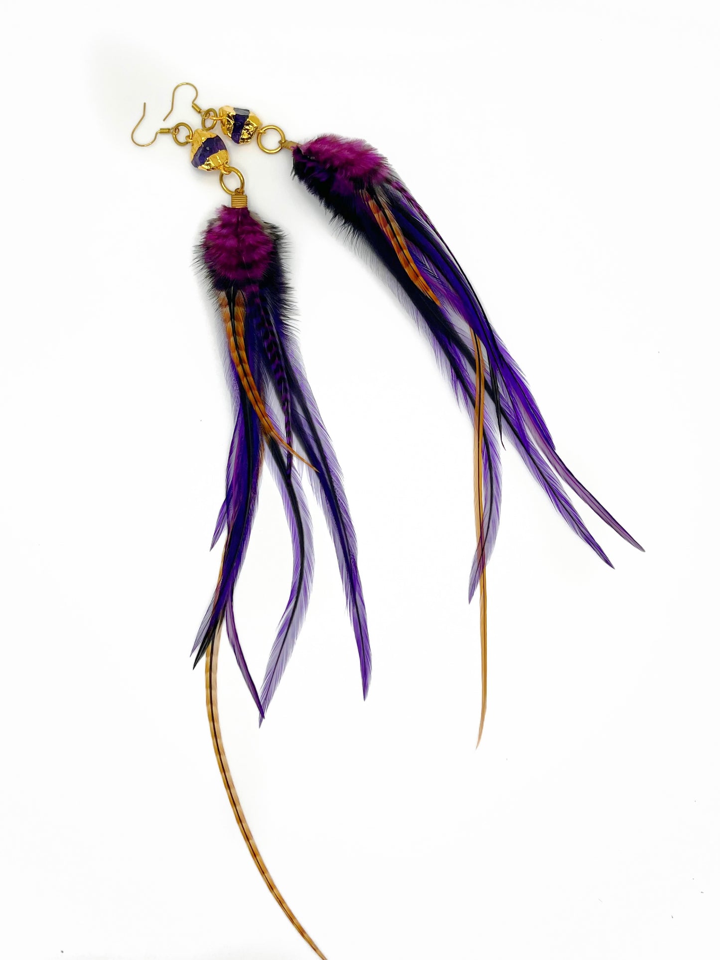 Long purple feather earrings. Feathers hang from a gold dipped amethyst pendant.