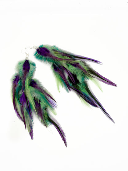 Long green and purple feather earrings. 