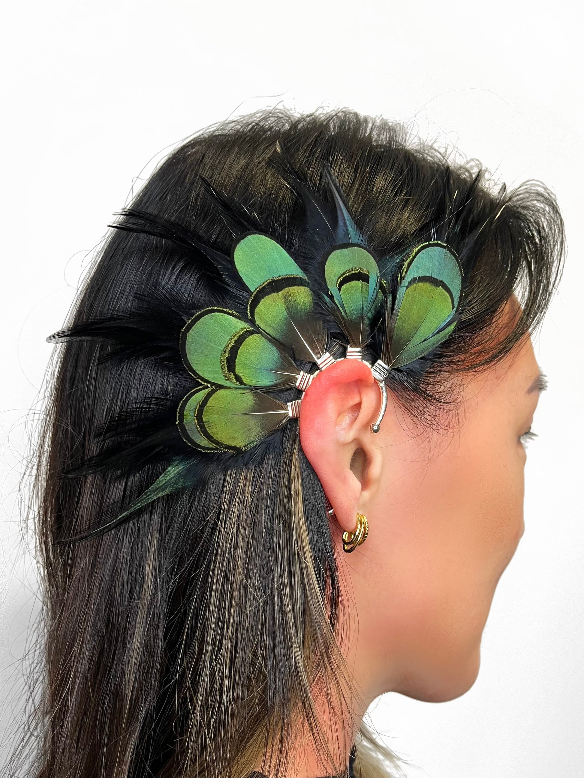 Black rooster and emerald green lady Amherst feather ear cuff modeled on a woman. 