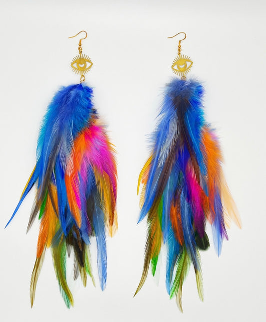 Long bohemian feather earrings with a gold eye pendant. Feathers are in vibrant blue, orange, yellow, pink and green colors. 