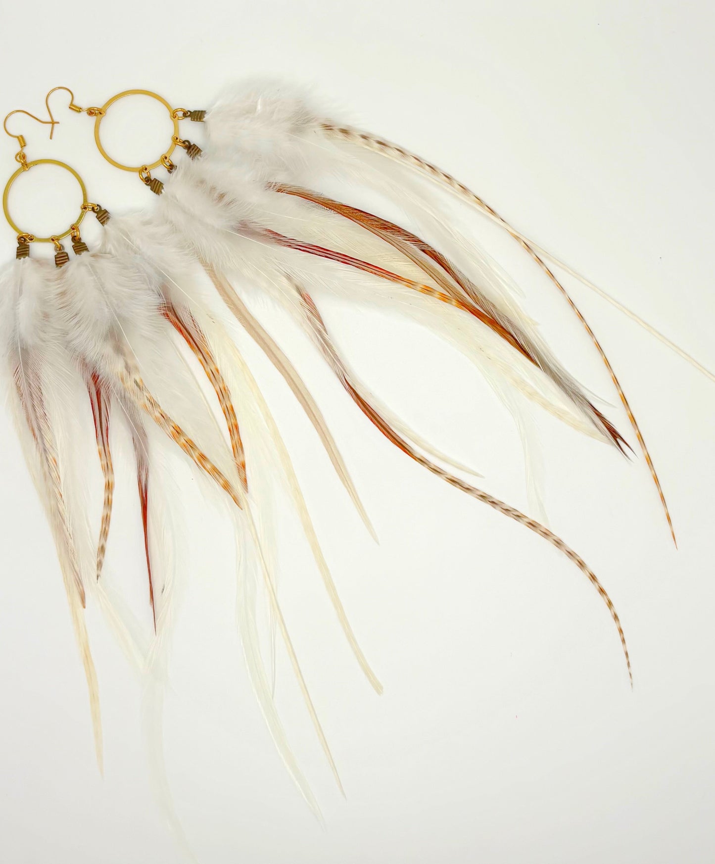 Feather earrings with gold accents on a white background