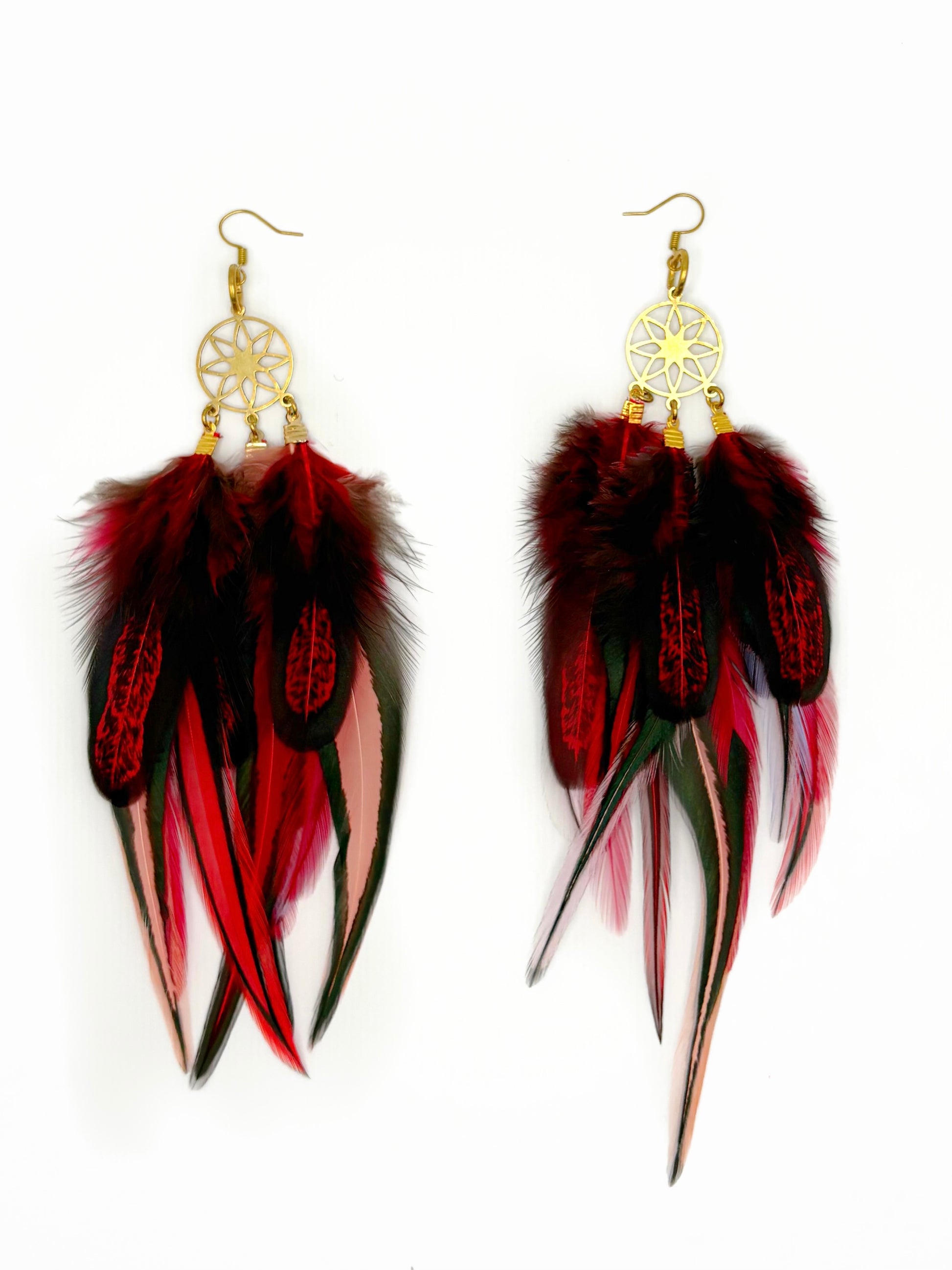 Feather earrings with red, black, and pink feathers on a white background
