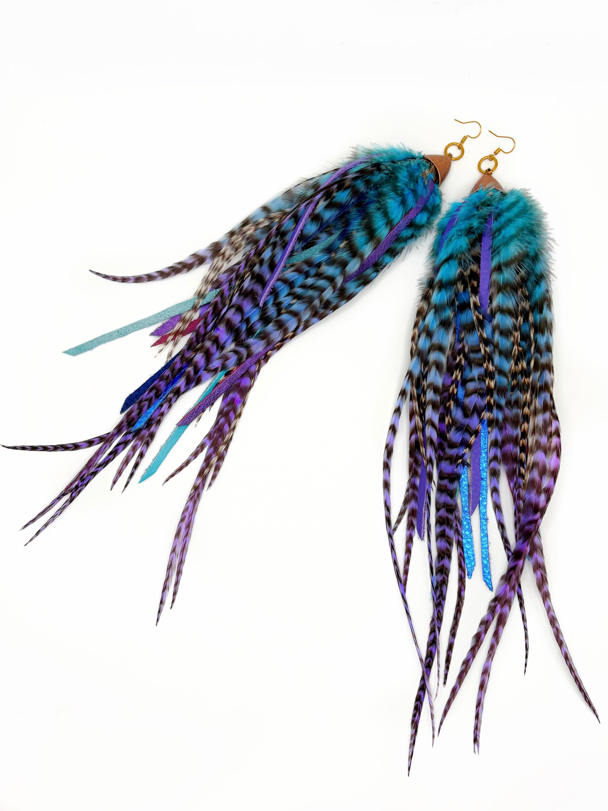 Feather earrings with blue and purple accents on a white background