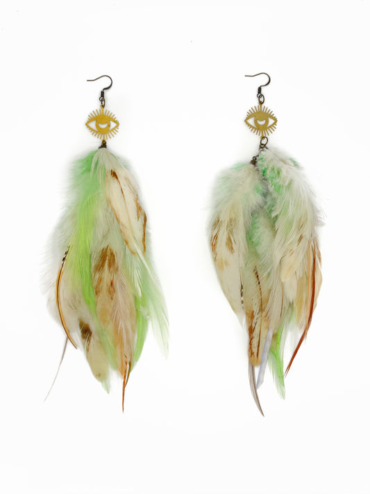 Long cream and green feather earrings with gold eye pendants. 