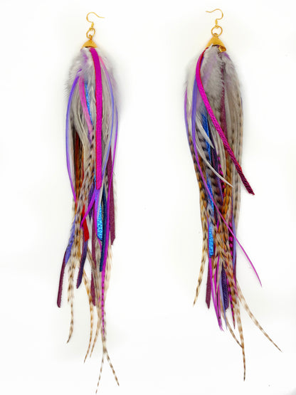 Multicolored feather earrings on a white background