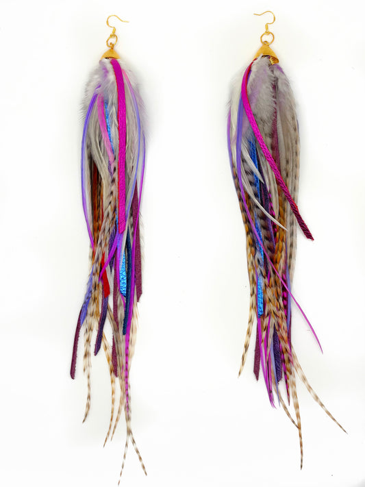 Multicolored feather earrings on a white background