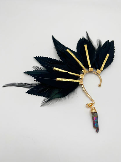 Structured black feather ear cuff with gold leather accents and a wire wrapped black quartz stone that hangs from the bottom of the cuff. 