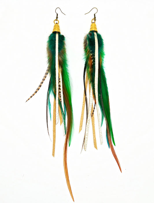 Long rooster feather earrings in brown and green tones with metallic pewter colored leather, hanging from a gold colored cap.