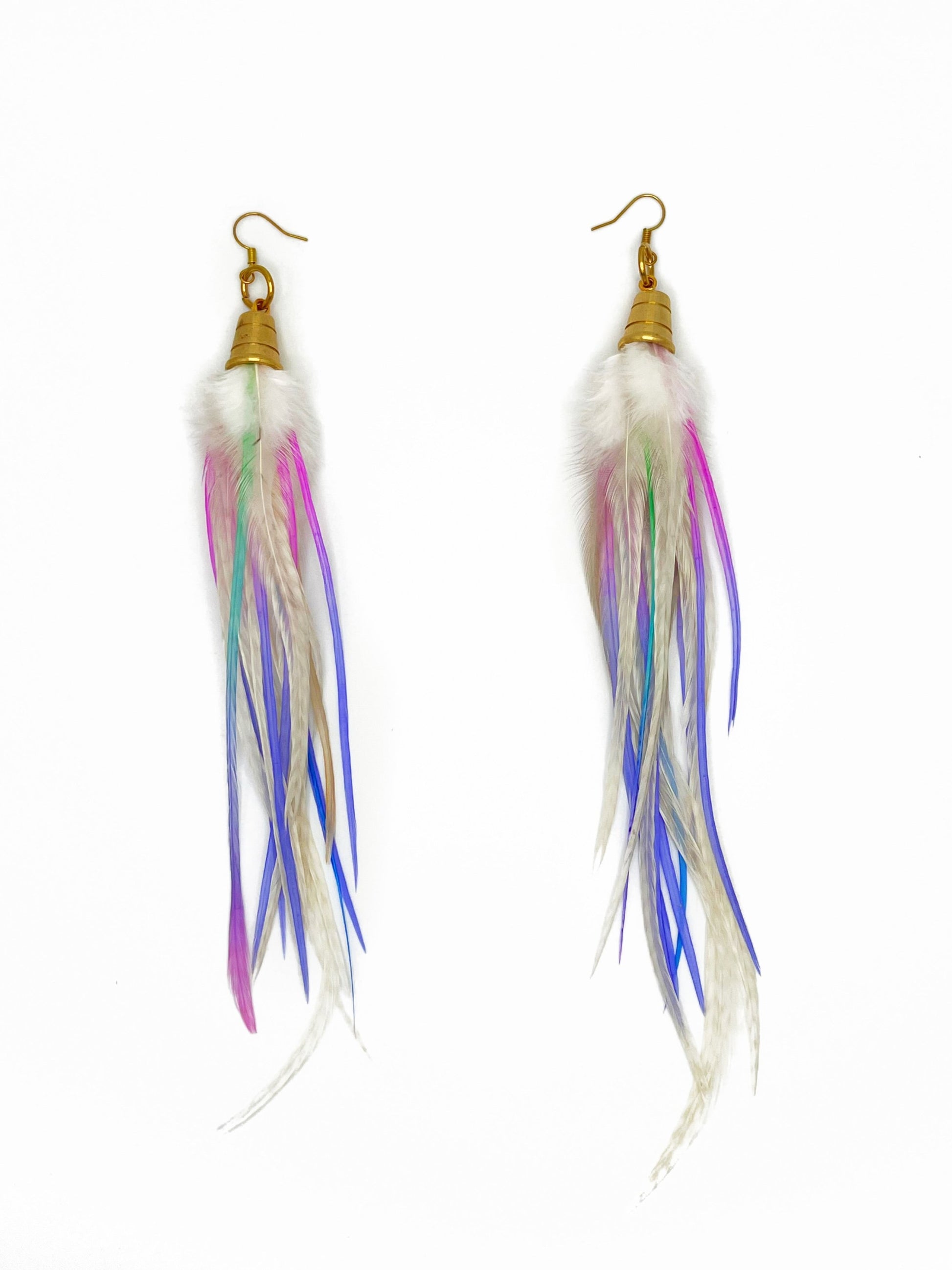 Long white feather earrings with pastel purple and pink accents. All feathers hang from beneath a gold cap pendant. 