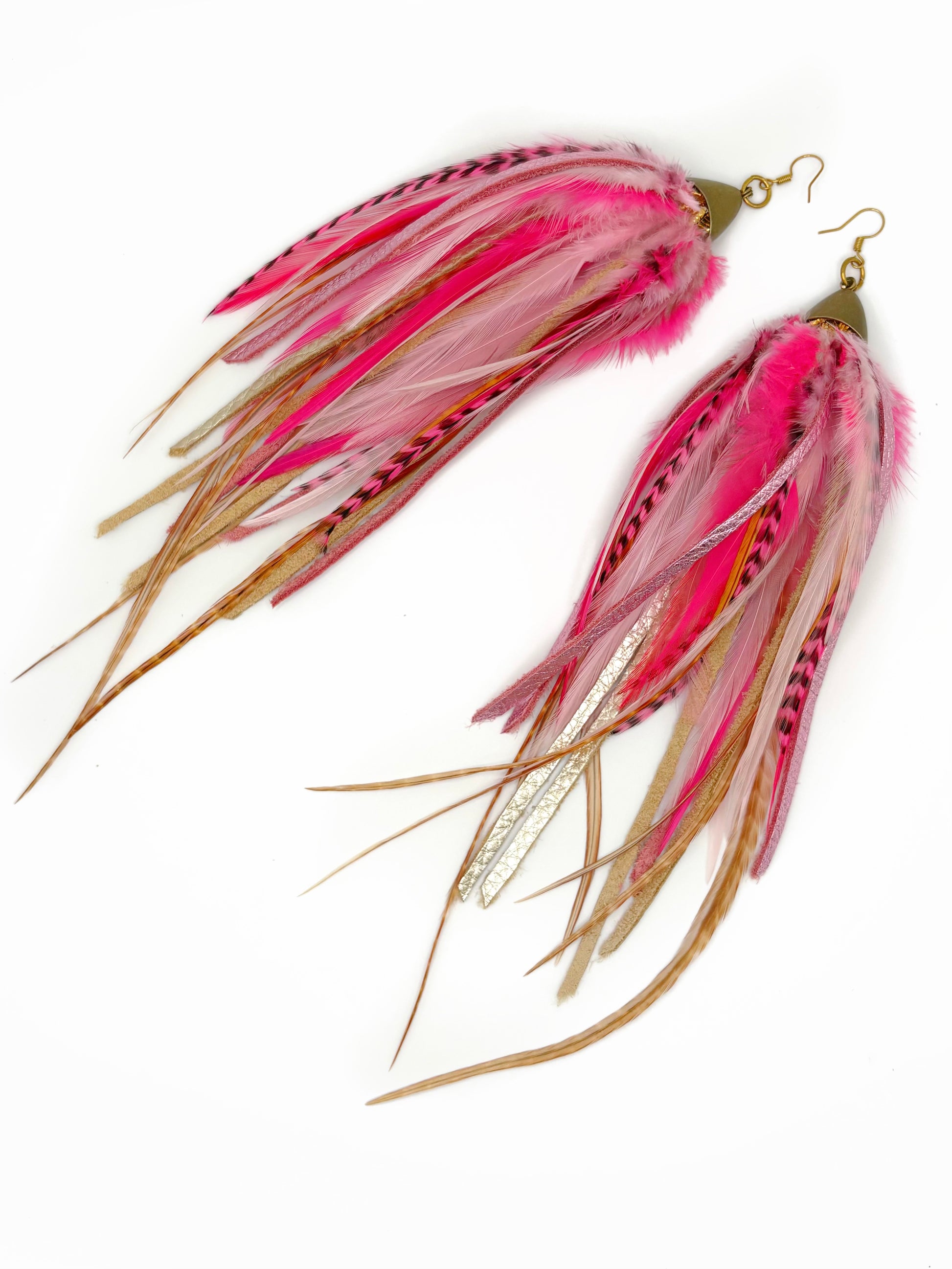 Pink and gold feathered earrings on a white background