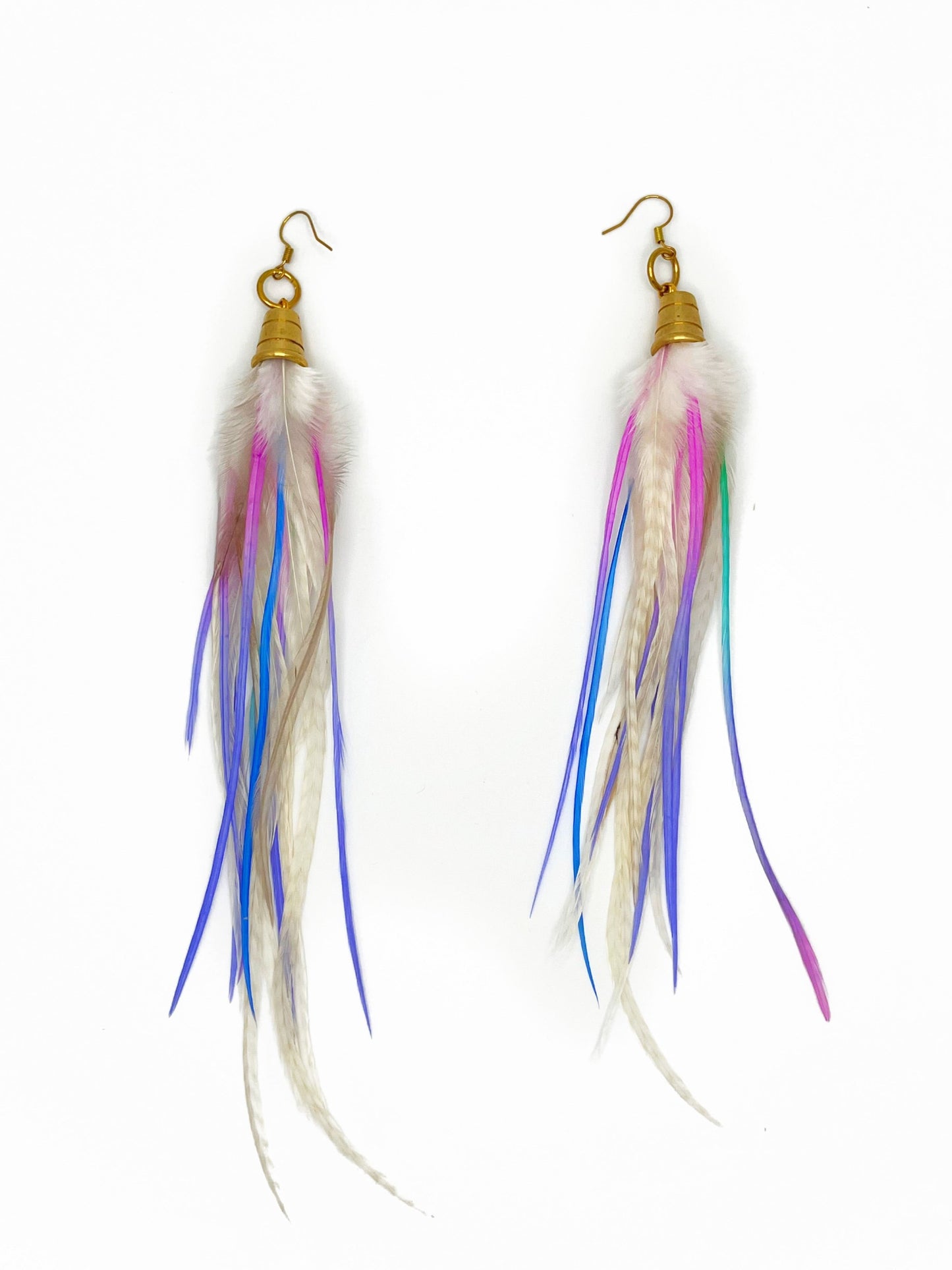 Long white feather earrings with pastel purple and pink accents. All feathers hang from beneath a gold cap pendant. 