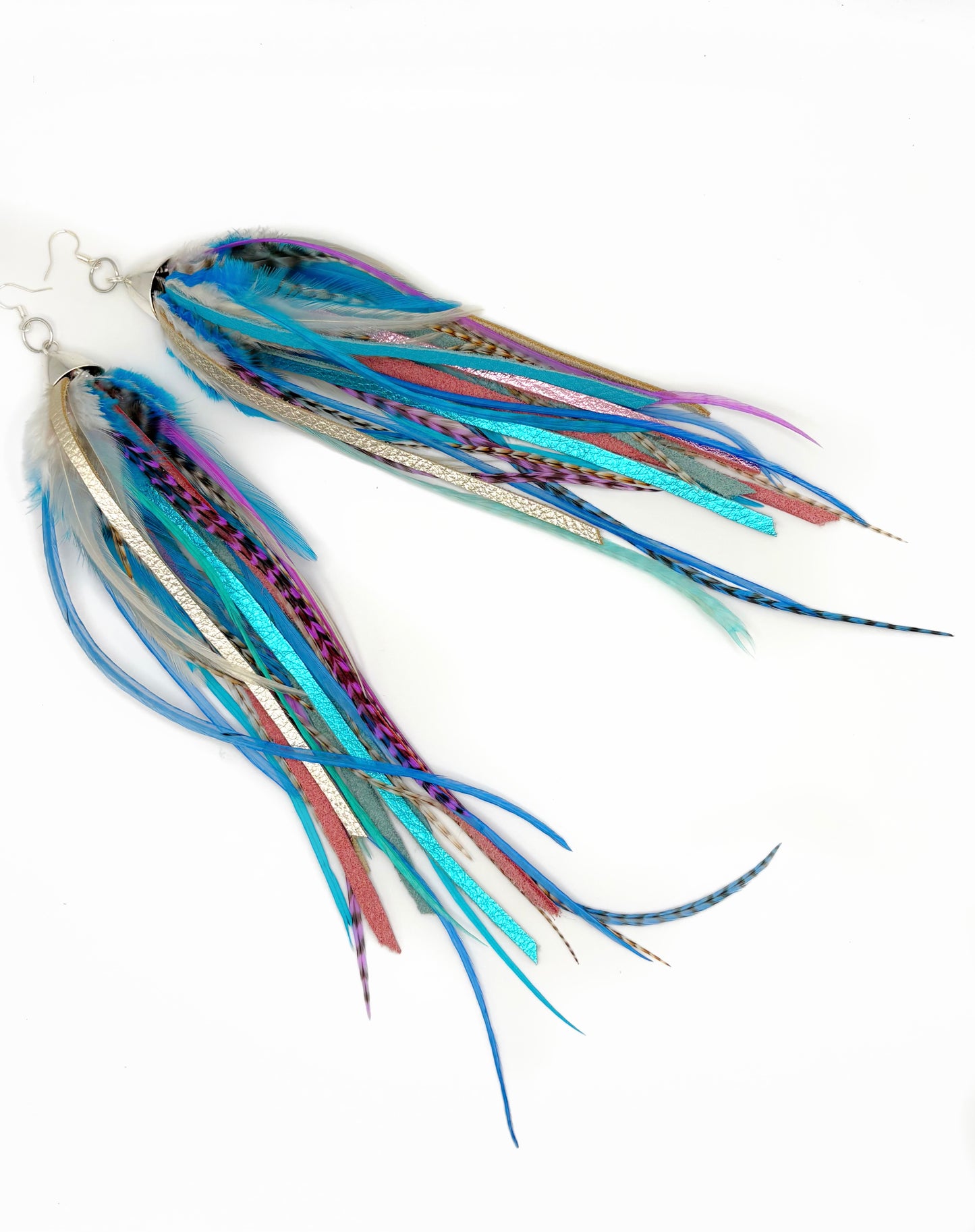 Two colorful fishing lures with multicolored skirts on a white background