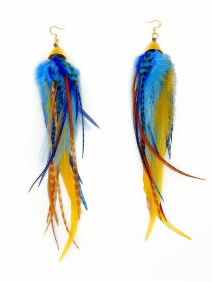 Long bohemian feather earrings with navy blue, light blue, golden yellow, brown and beige rooster feathers cascading from gold cap pendants, handmade in Brooklyn.