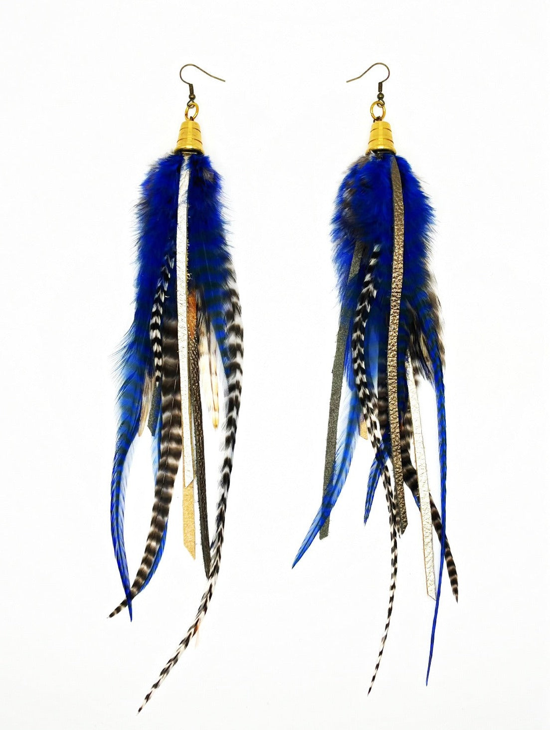 Long feather earrings in dark blue and natural colors, with strips of metallic pewter and bronze leather, hanging from a gold colored cap pendant.