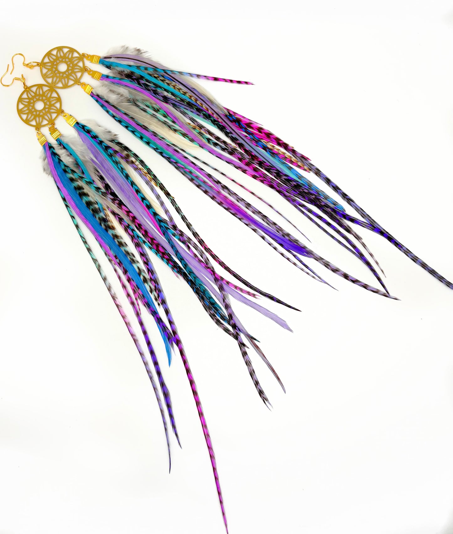 Colorful feather earrings on a white background
