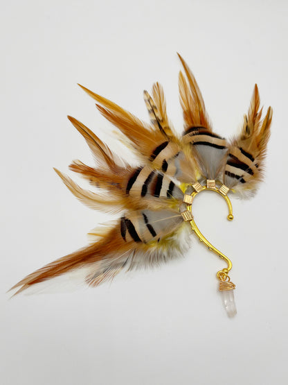 Rooster and chukar partridge feather ear cuff in white, cream, yellow and beige tones. A wire wrapped quartz dangle hangs from the bottom of the cuff.