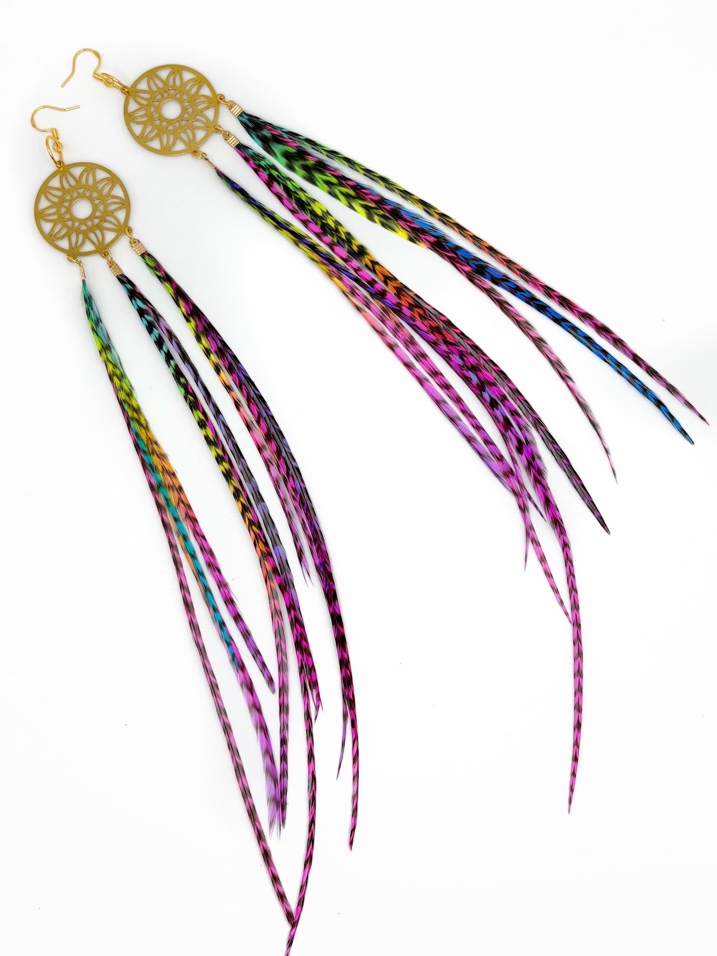 Colorful feather earrings with gold dreamcatcher designs on a white background