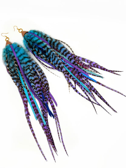 Pair of colorful feather earrings on a white background